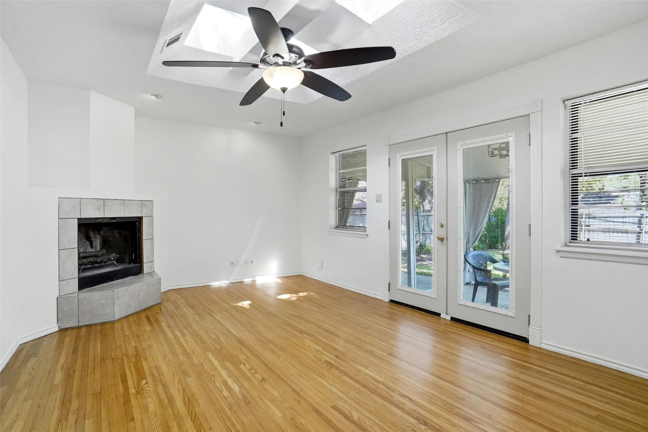 Coffered ceiling with Skylights! Overlooks backyard with glass French doors!