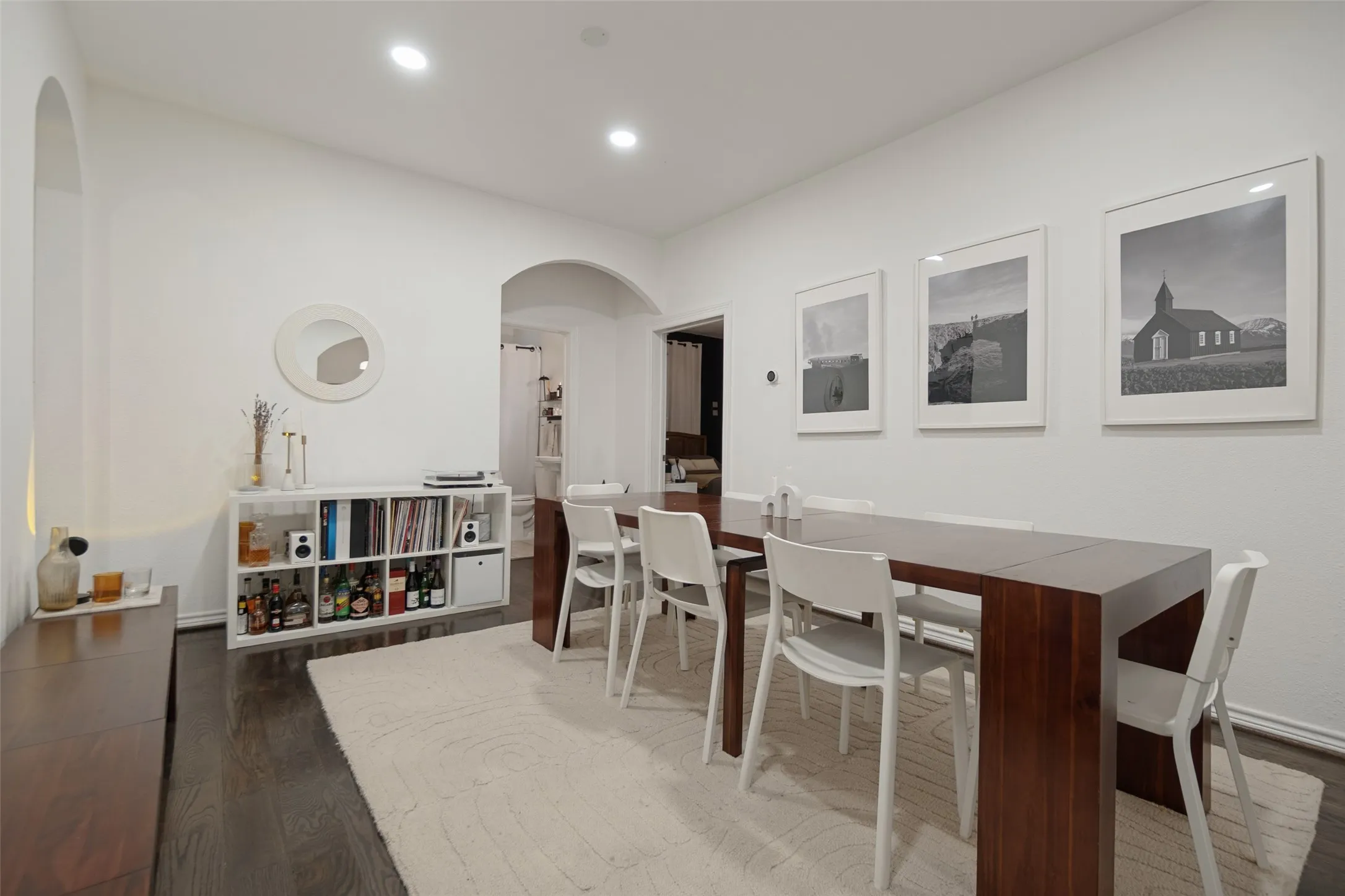 Arched doorways, recessed lighting, and dark wood-finish flooring