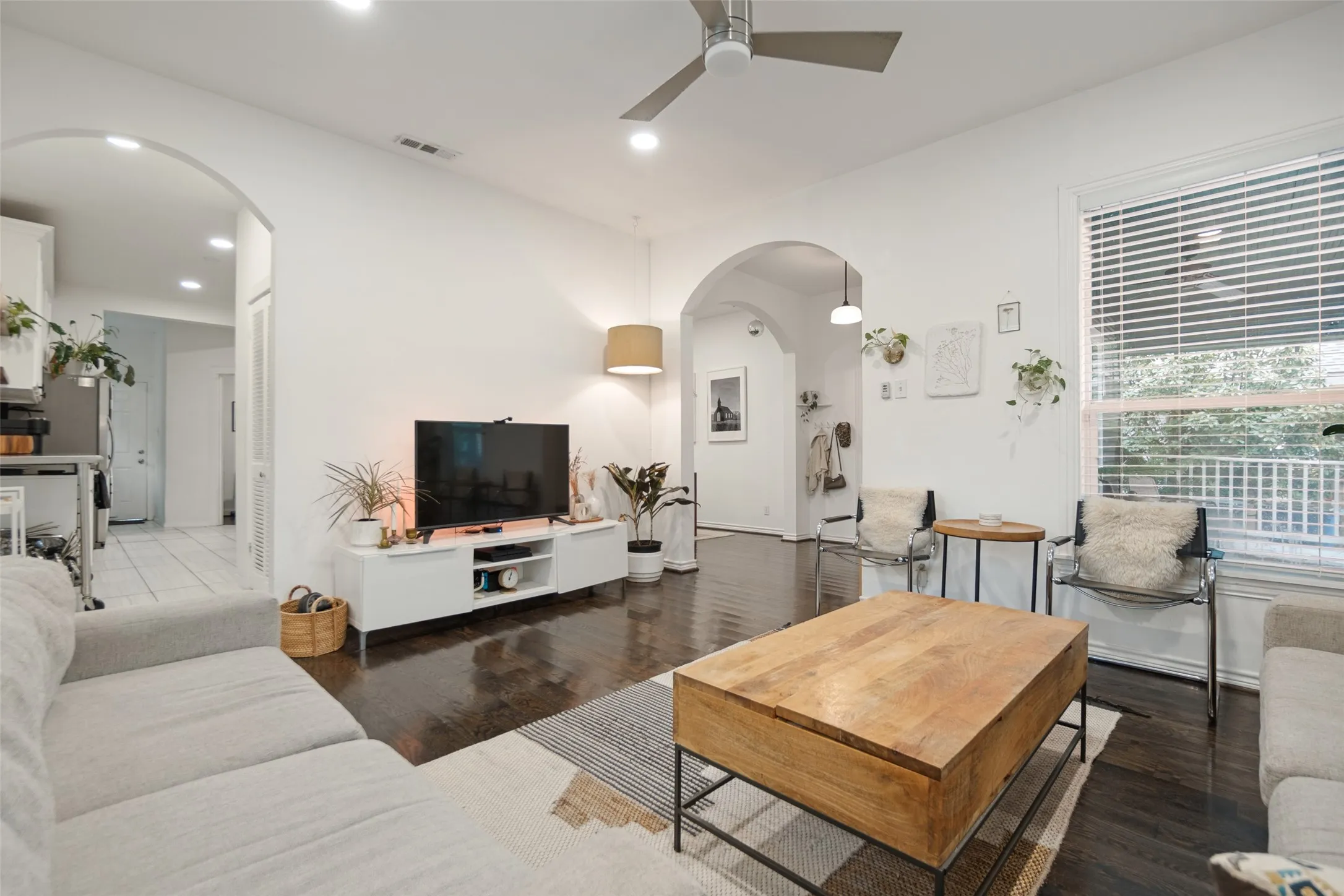 Dark wood-finish flooring with recessed lighting