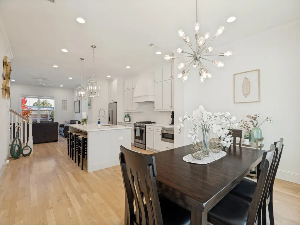 Open-concept living area with light wood-finish flooring