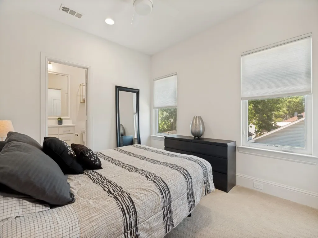 Carpeted bedroom featuring white walls, recessed lighting, and a ceiling fan