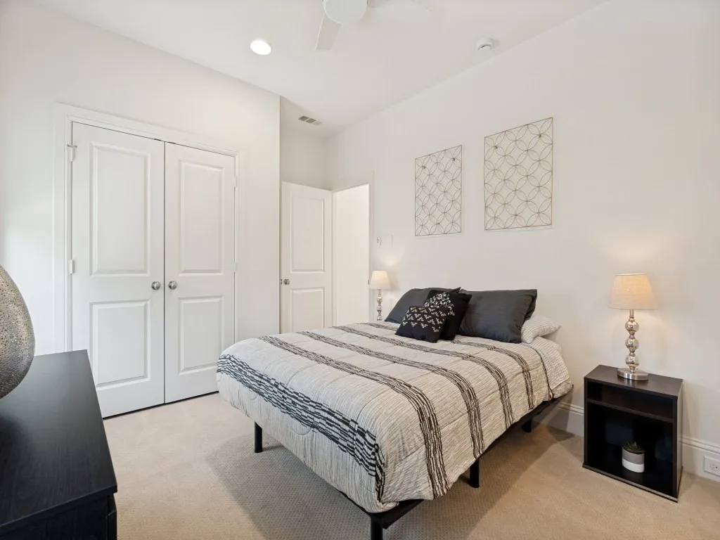 Carpeted bedroom featuring a double-door closet, ceiling fan, recessed lighting, and white walls