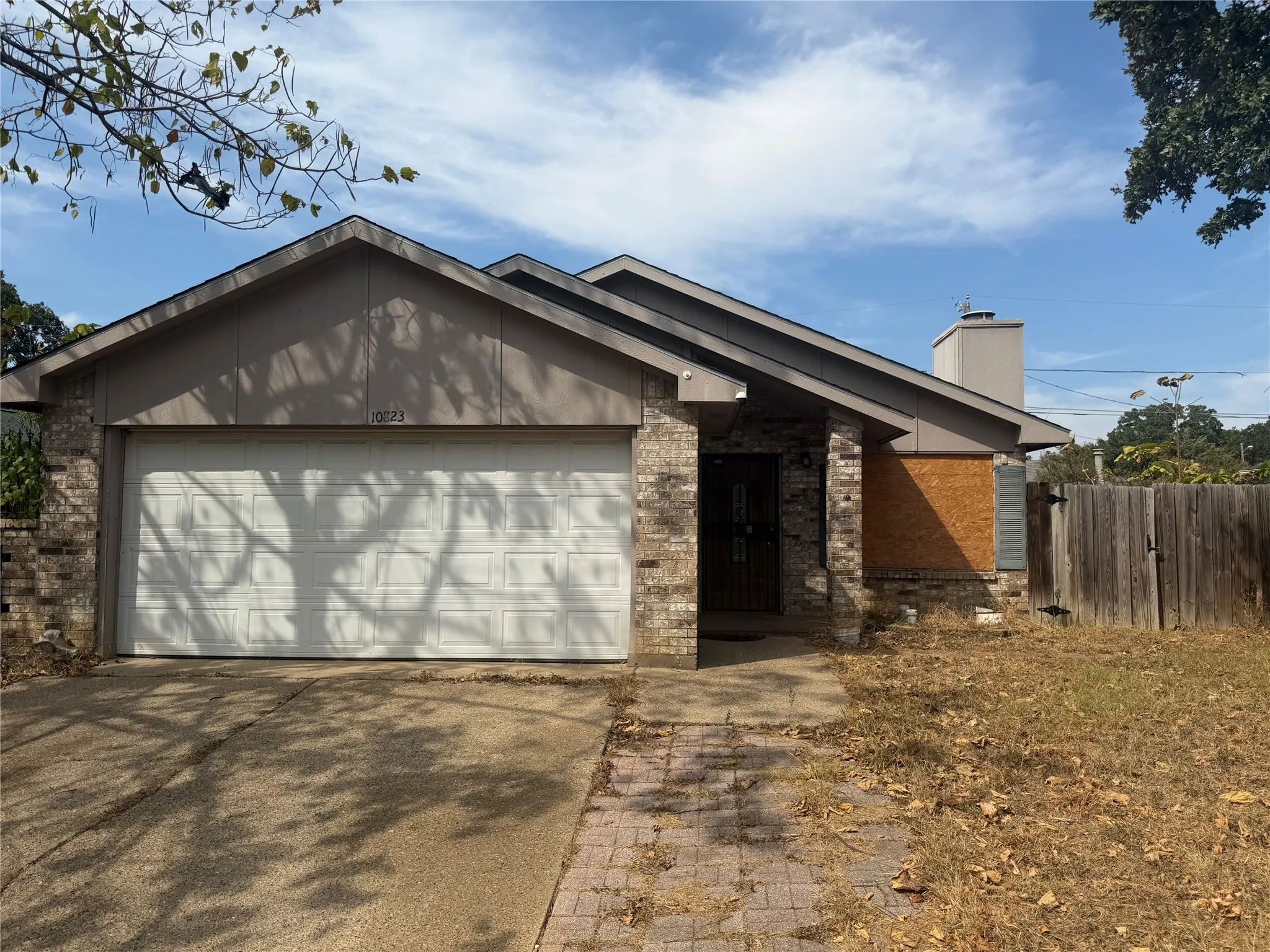 Brick facade with a prominent front-facing gable and an attached two-car garage