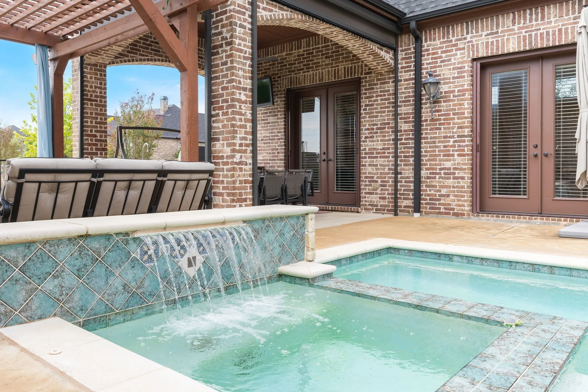 Heated pool with waterfall feature.