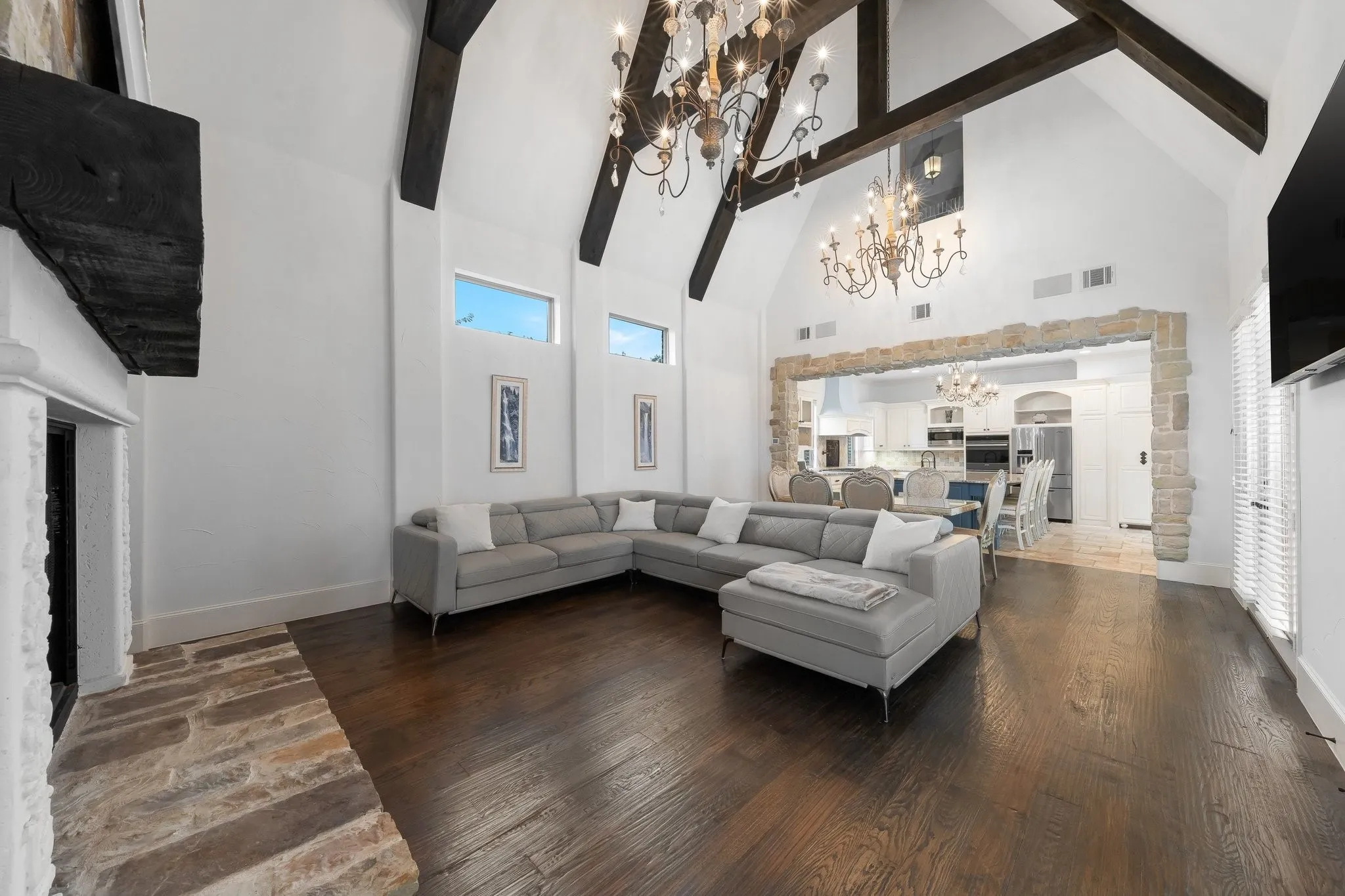 Large gathering room and dining area are open to the kitchen, and both have direct access to the outdoor living space.