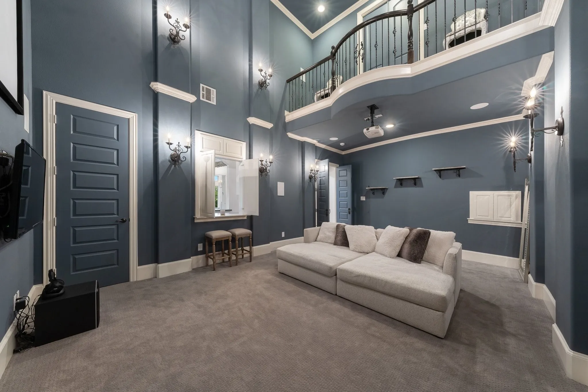 Impressive 2-story media room with pass-through window to game room service bar.