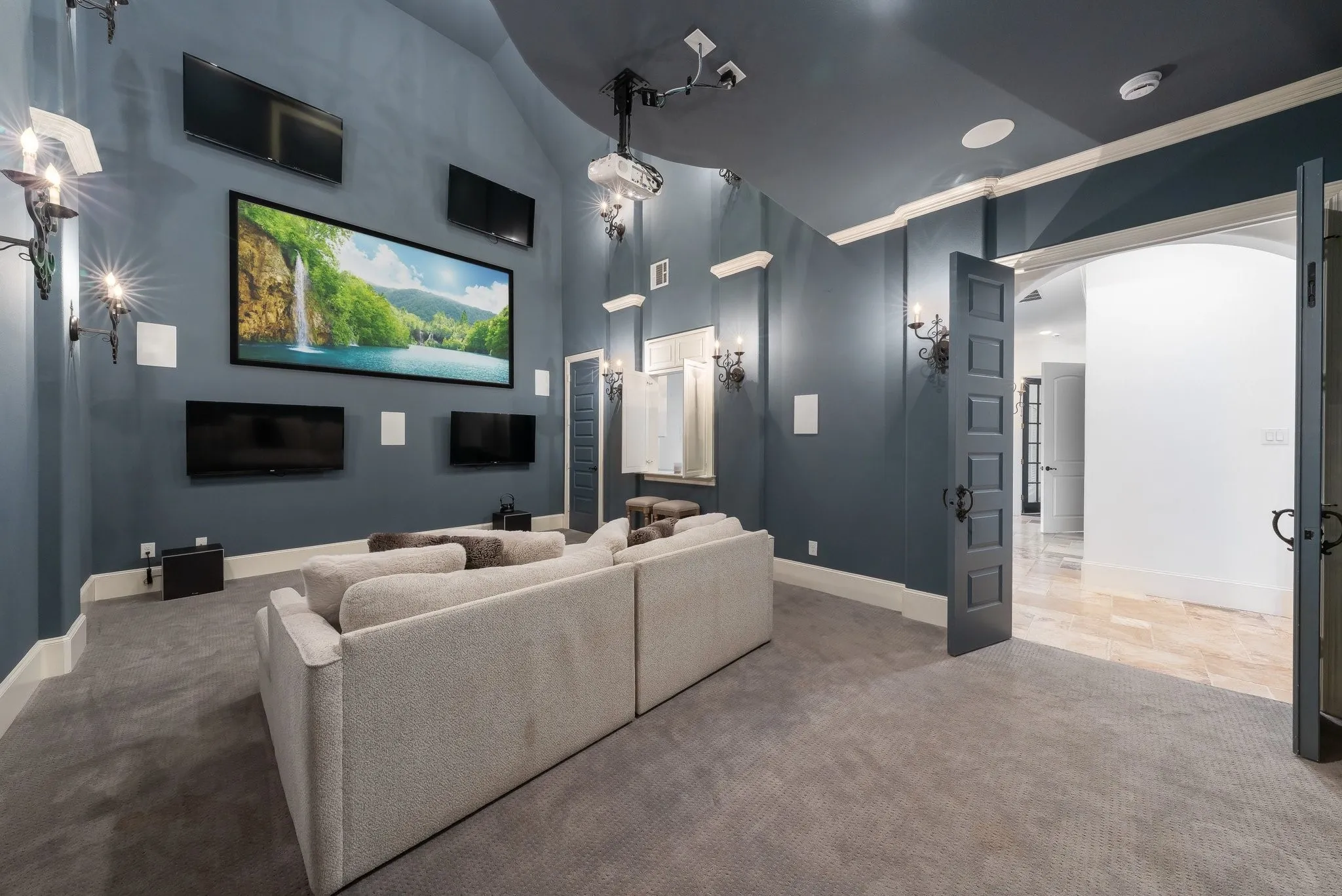 Media room has multiple TV screens for entertaining or sports enthusiast.