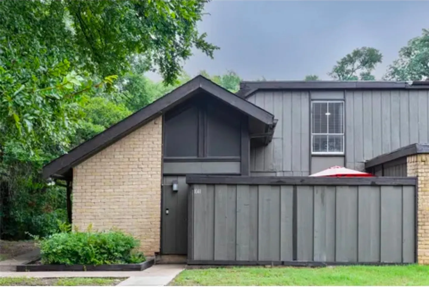 Brick and vertical panel siding exterior with an A-frame architectural element