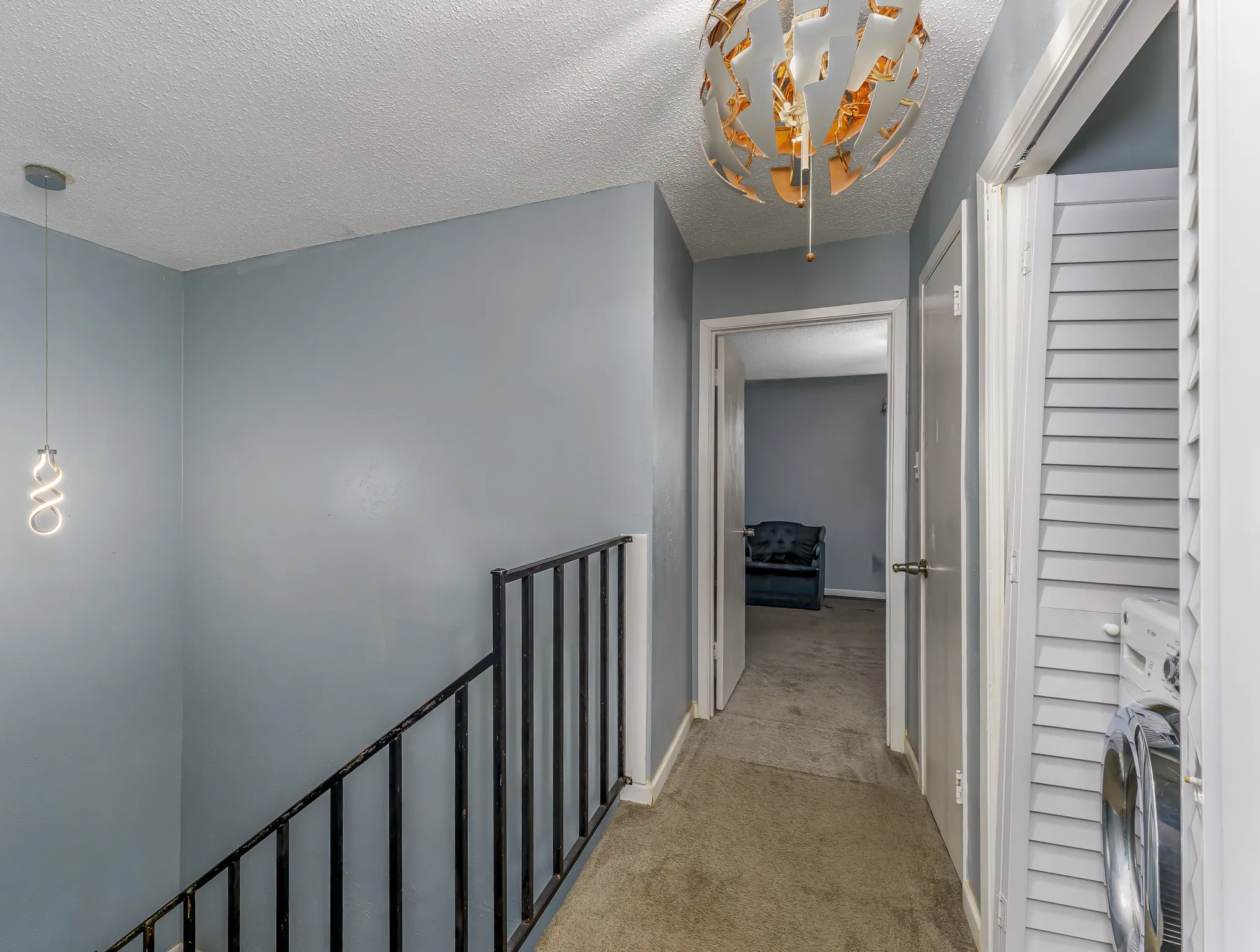 Textured ceilings, pendant lighting, and a modern ceiling fixture illuminate interior spaces