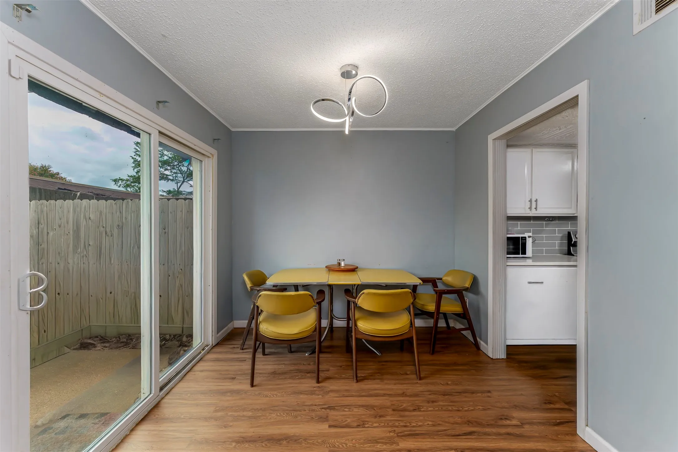 Wood-finish flooring throughout, with a contemporary ceiling light fixture