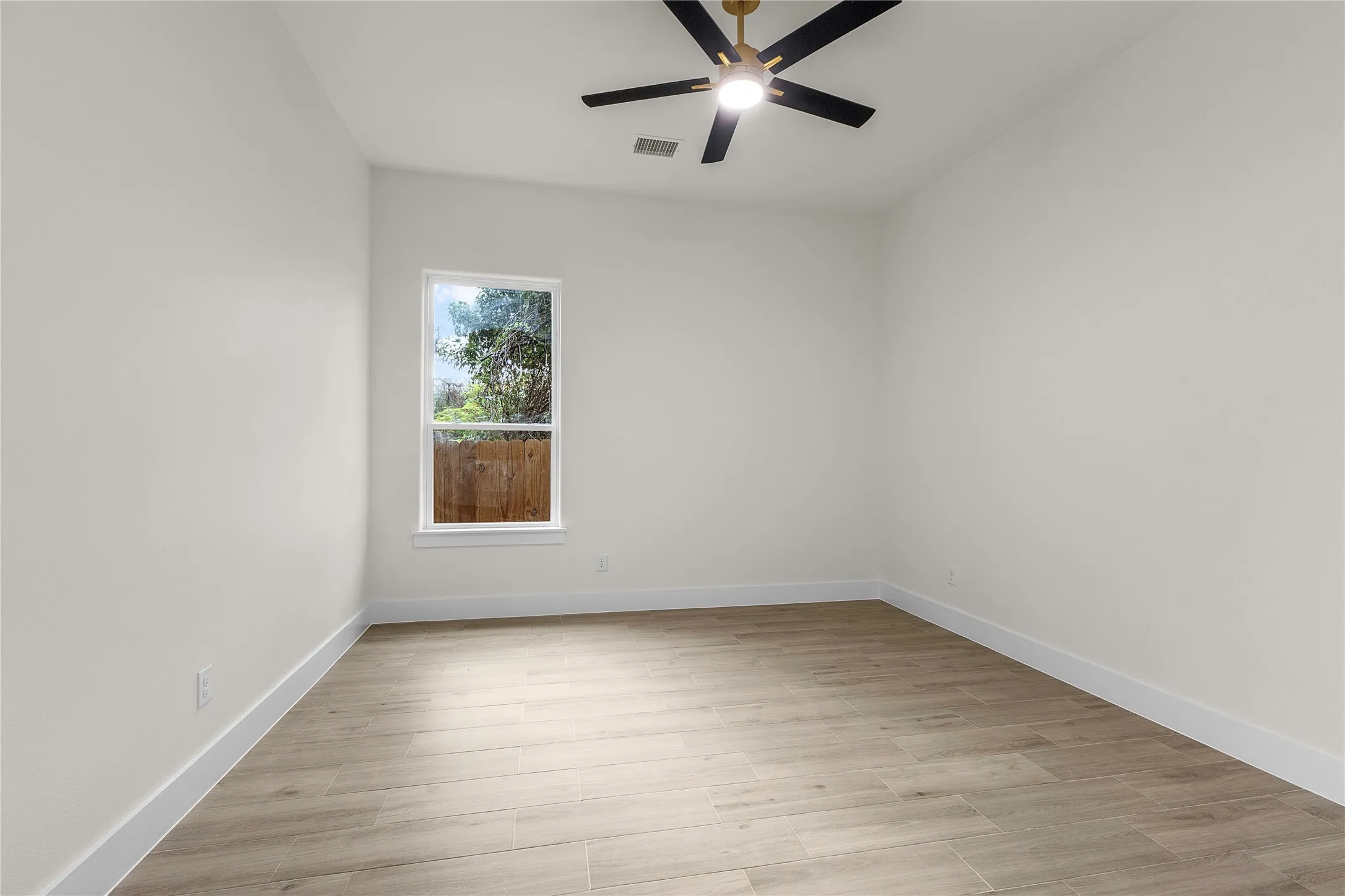 Recessed lighting, wood-finish flooring, and a ceiling fan with light fixture