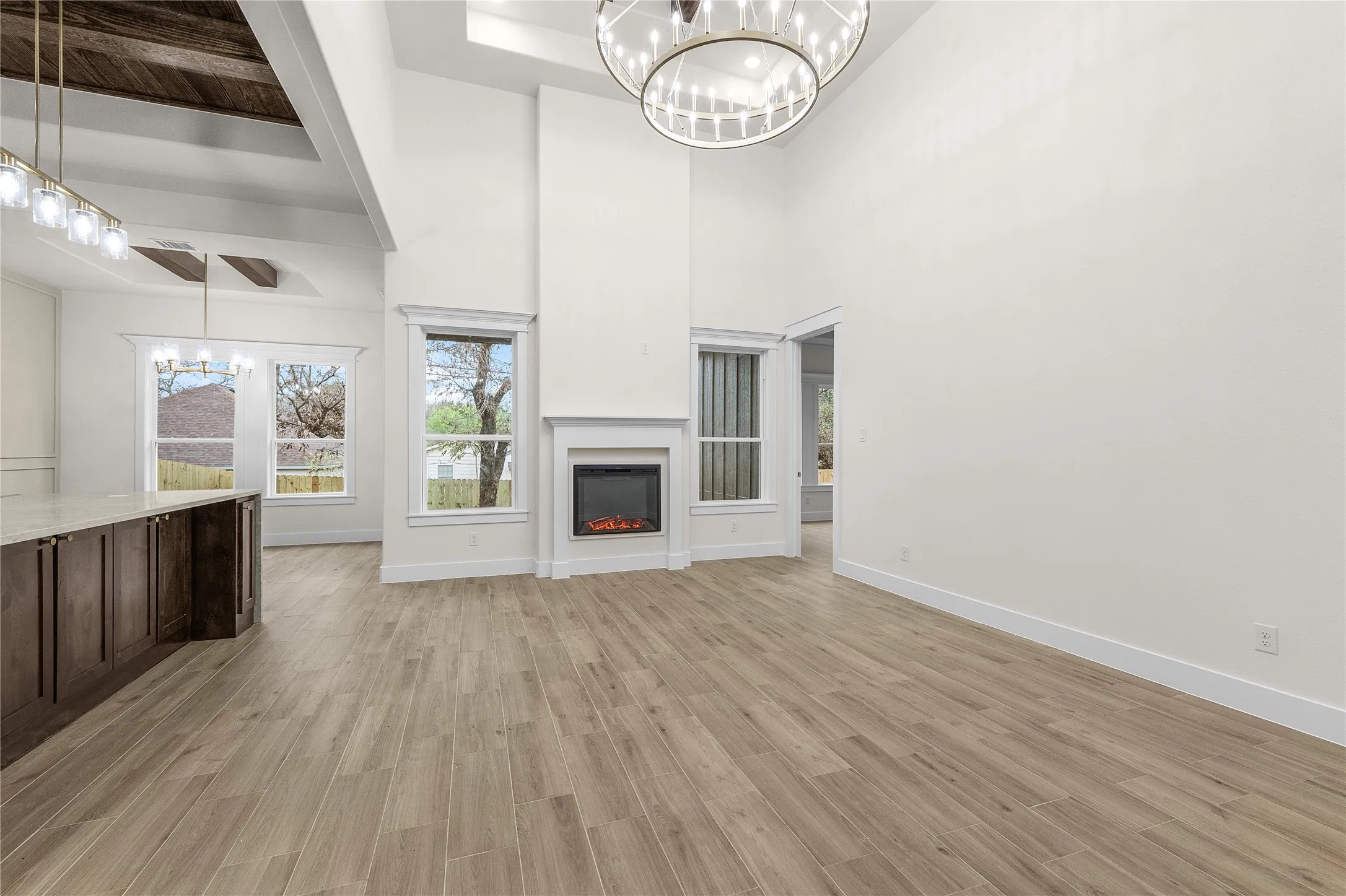 Vaulted ceilings, a built-in fireplace, and wood-finish flooring
