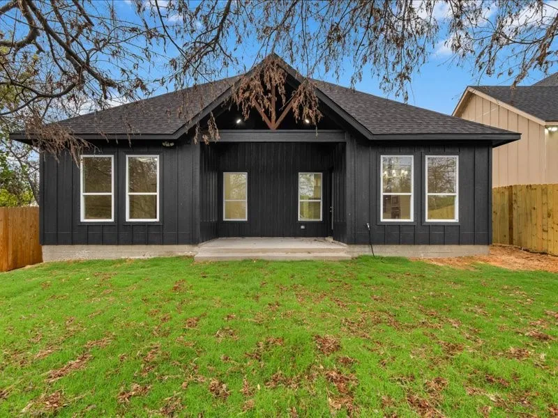 Contemporary black vertical siding with white-trimmed windows