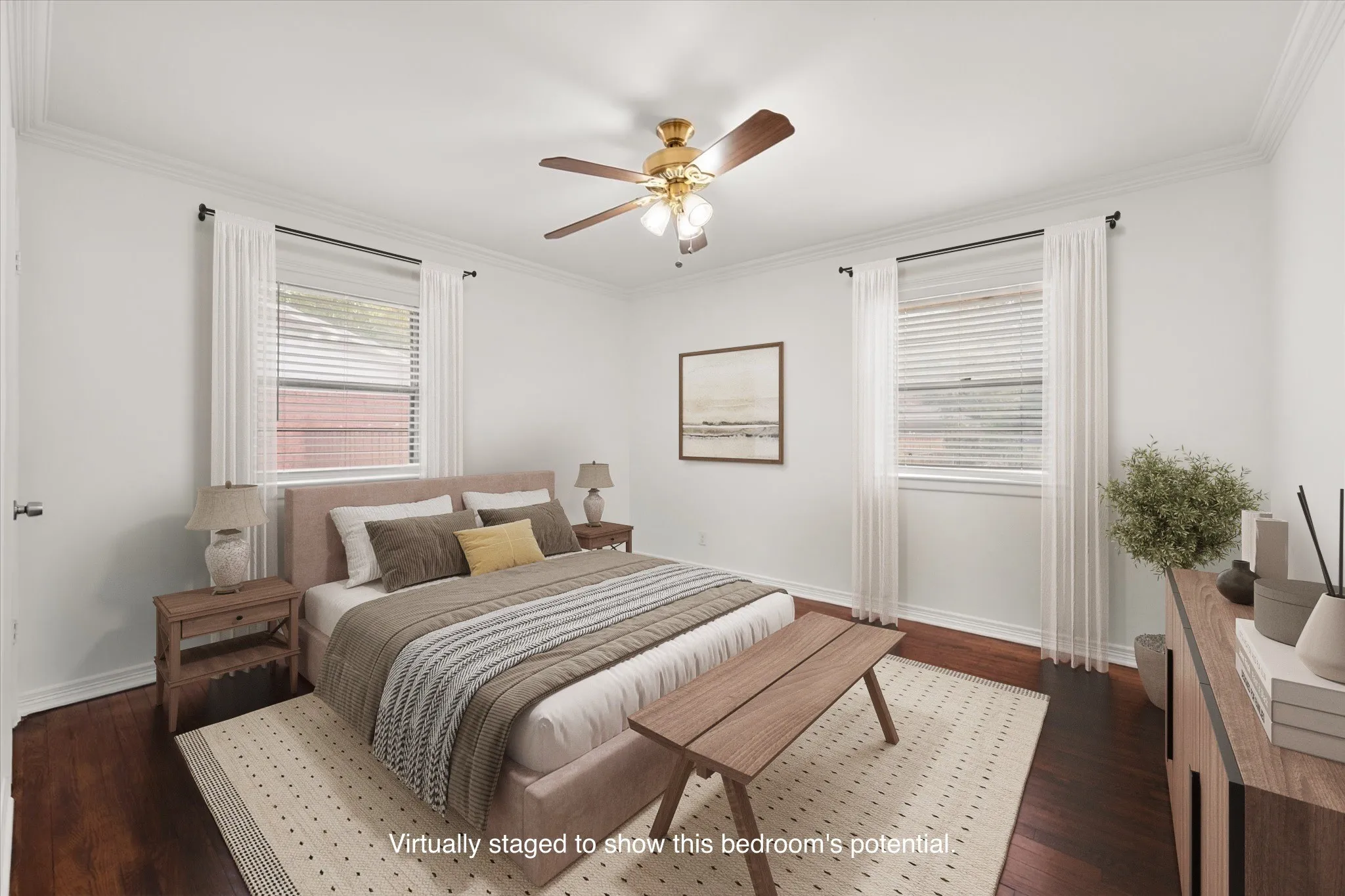 Hardwood flooring, crown molding, two windows with blinds, a ceiling fan with light fixture, and white painted walls
