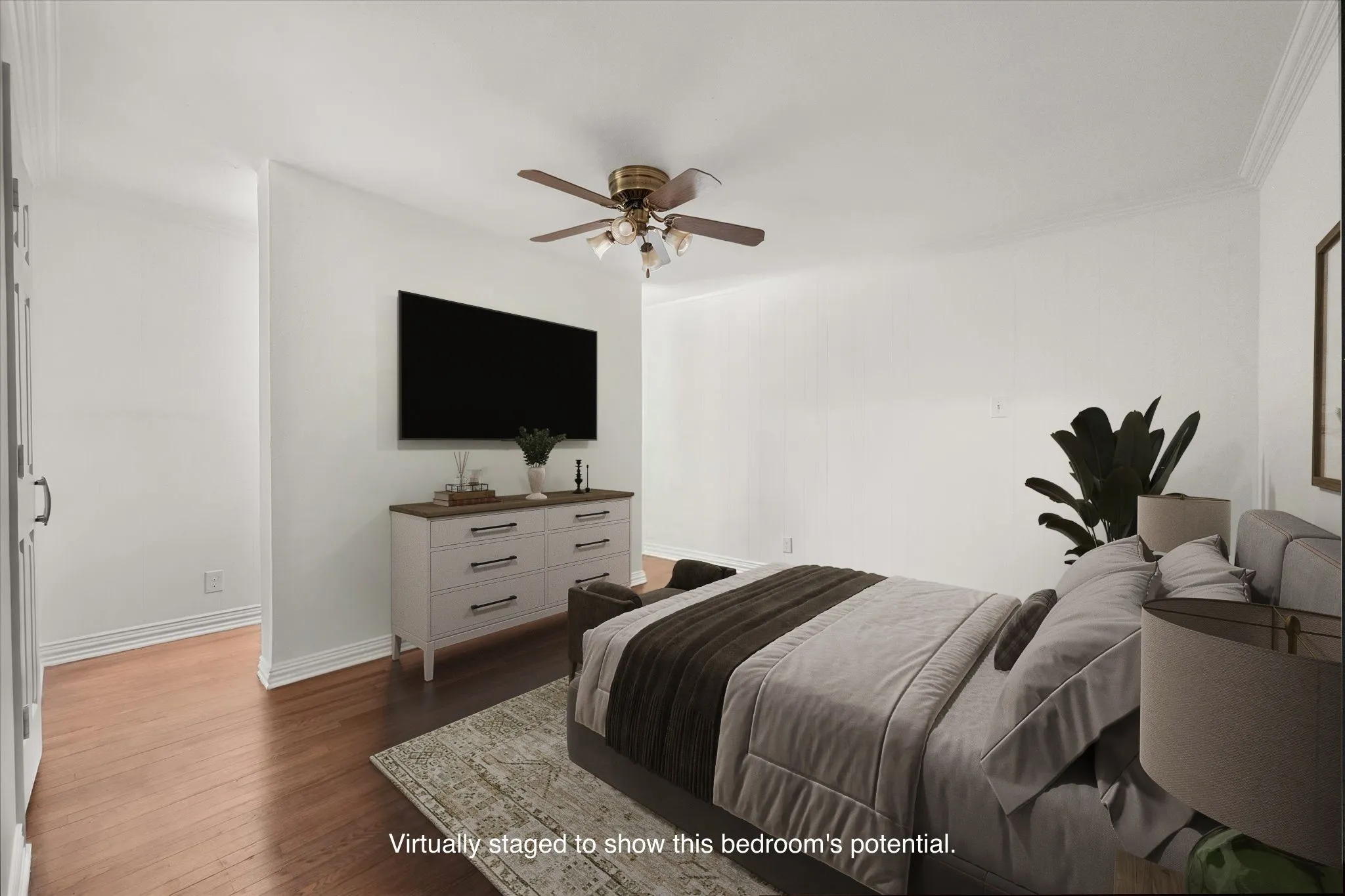 Wood-finish flooring, white walls, and a ceiling fan with integrated lighting