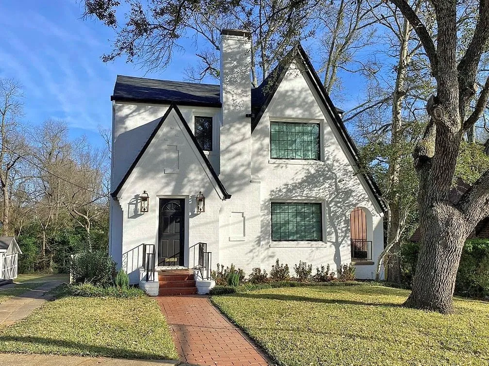 Stucco exterior with a prominent chimney and gabled rooflines