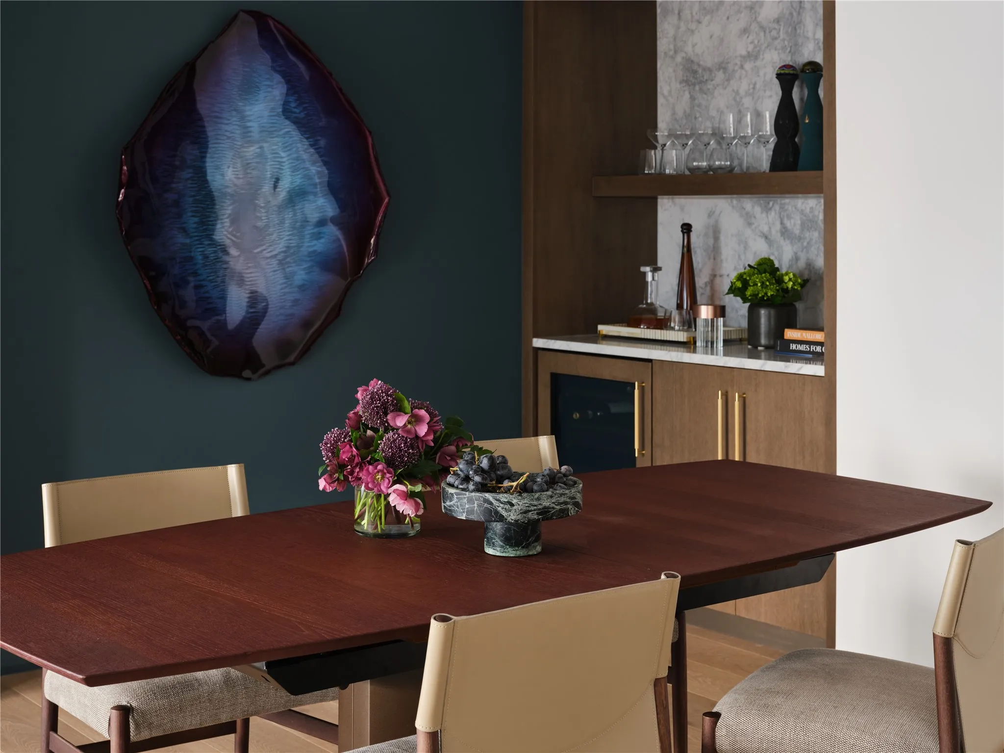 Dining roomand adjacent wet bar with wine refrigerator and marble backsplash.