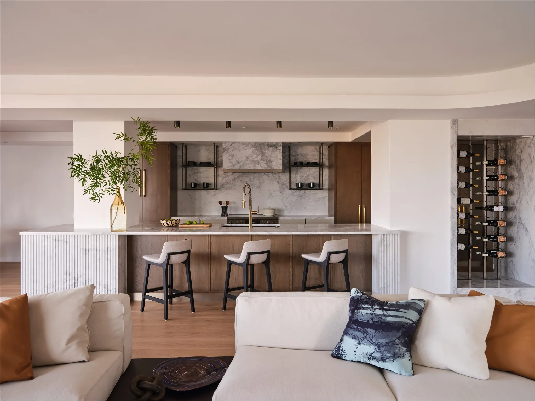 Chef's kitchen details include rift-cut white oak cabinetry with Arabesque marble and a wine feature wall.