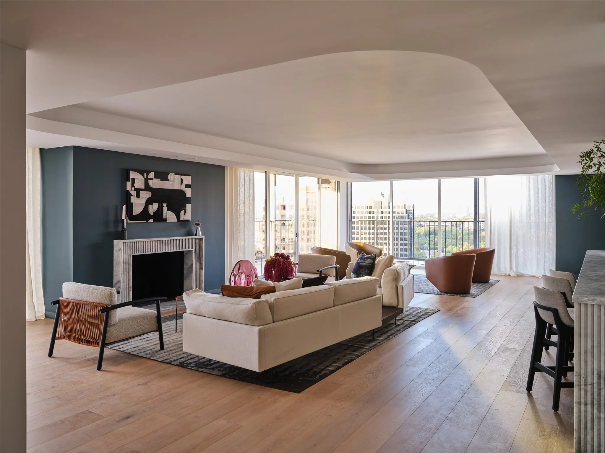 Living room has new floor-to-ceiling windows, LED cove lighting, and wood burning fire place with marble surround.