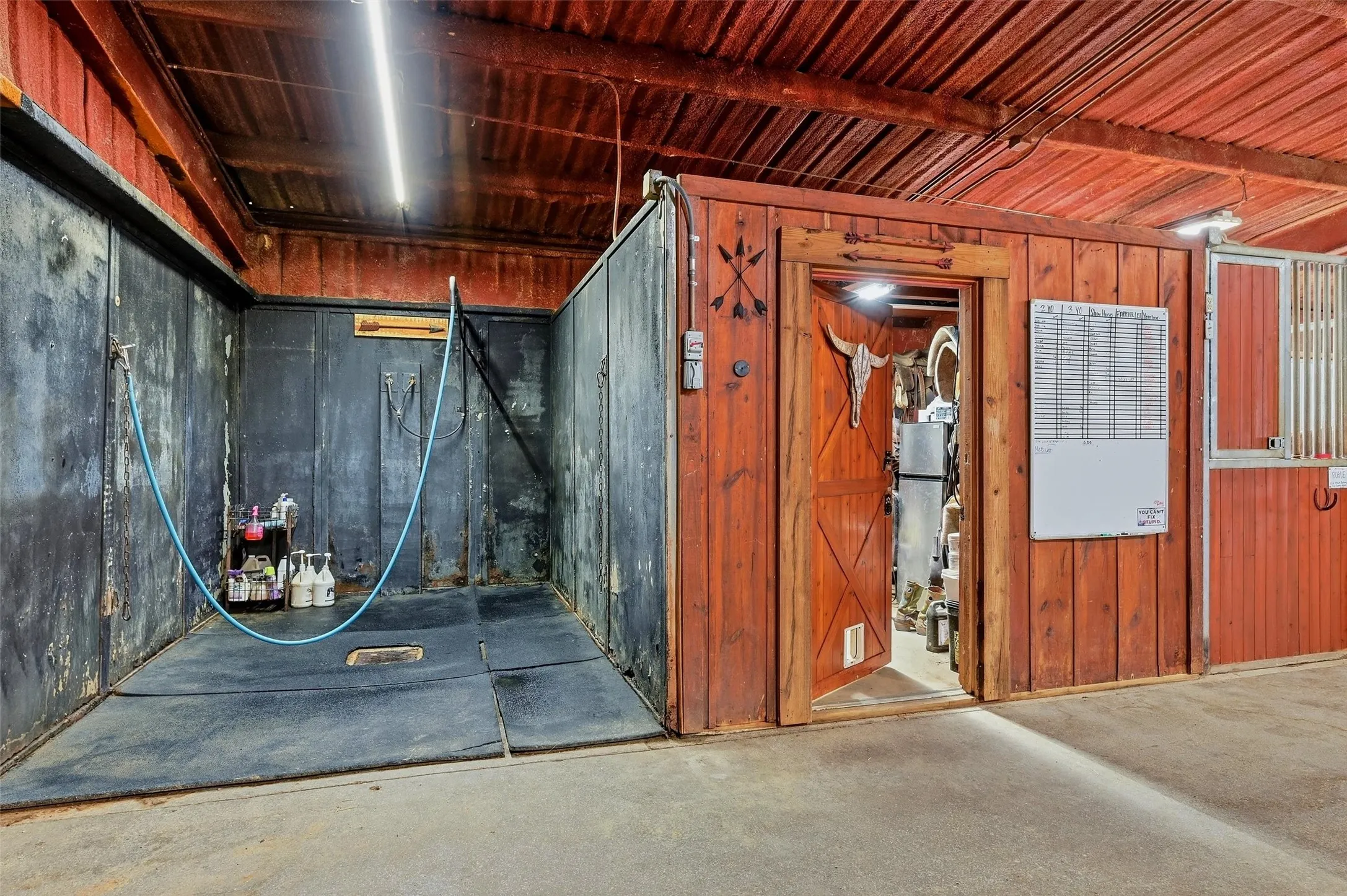 Wash rack with adjacent tack or storage room.