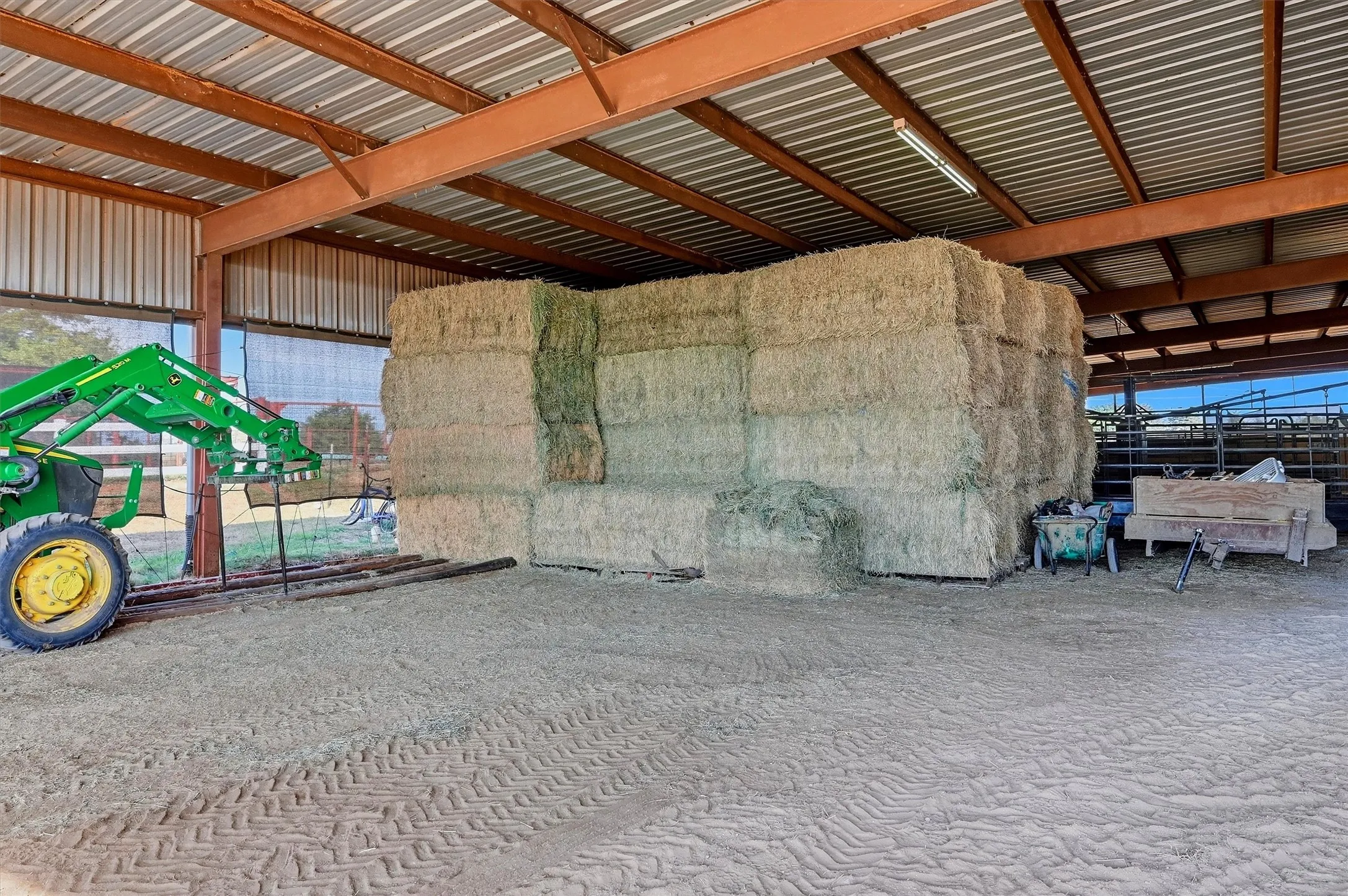 Covered area at end of arena can be used for feed and hay, or equipment or both.
