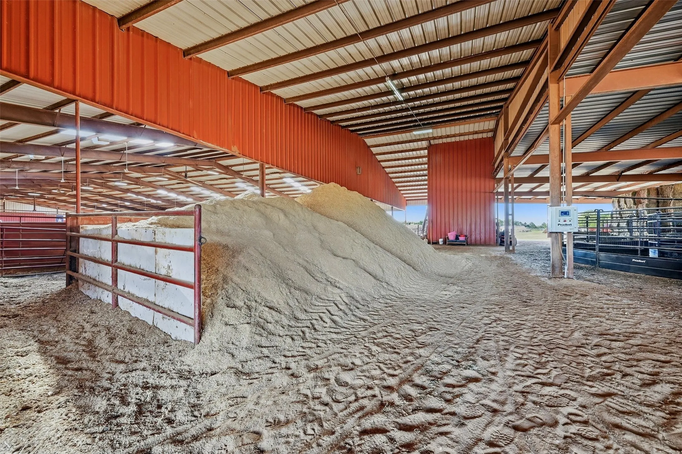 Covered storage area at end of arena  - currently holds sand.
