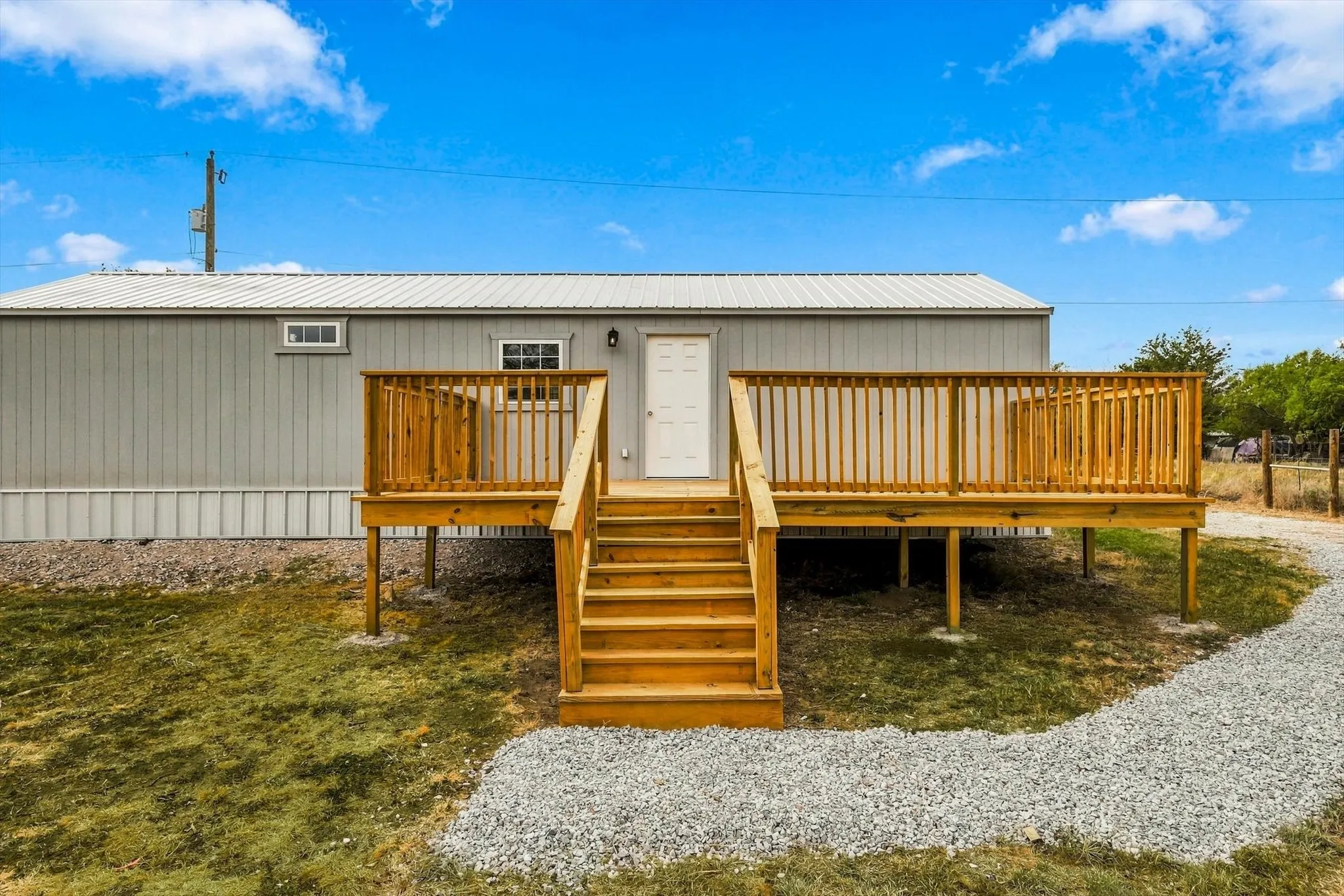 Spacious outdoor deck with natural wood railing and stairs