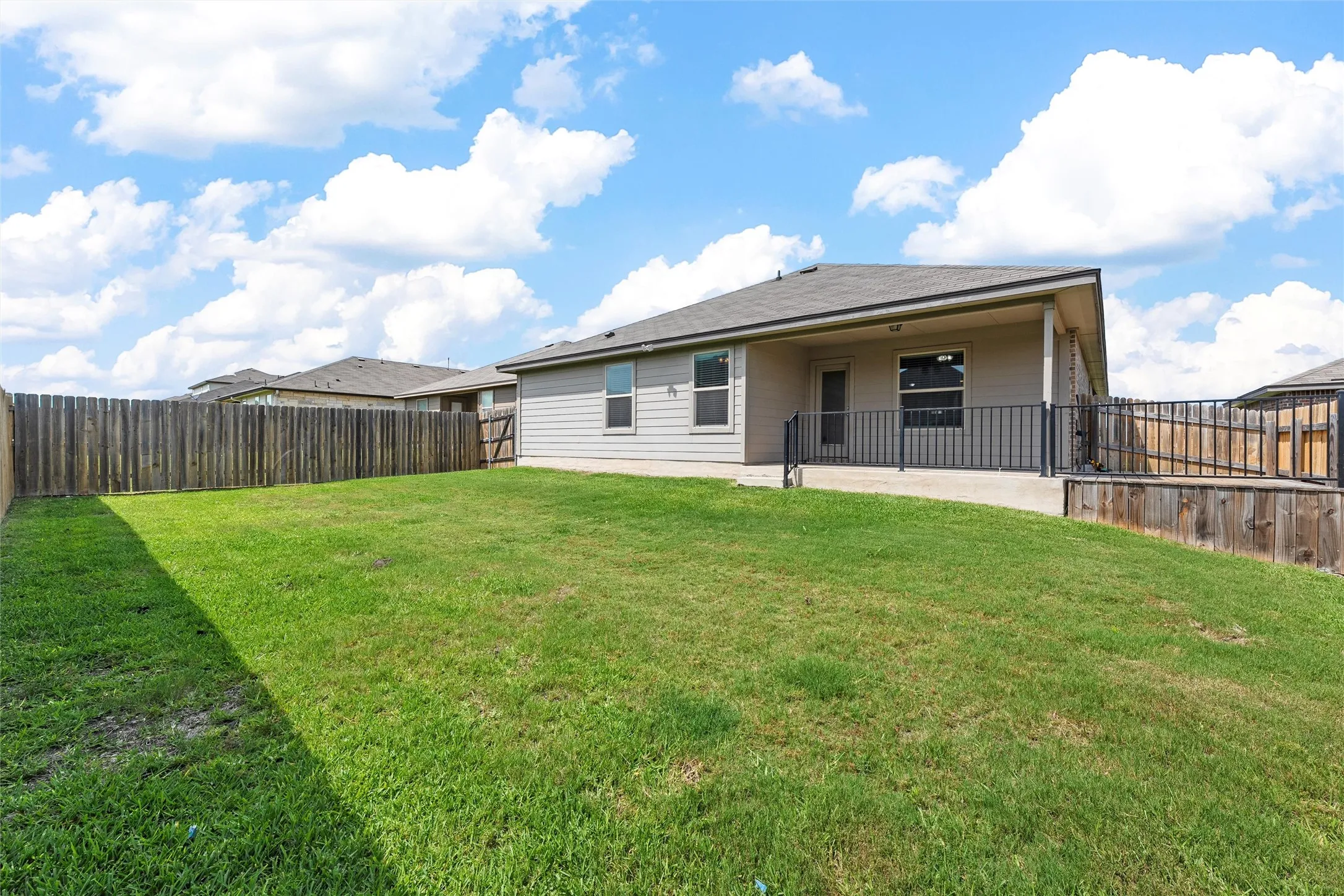 Back of house with a patio and a fenced backyard