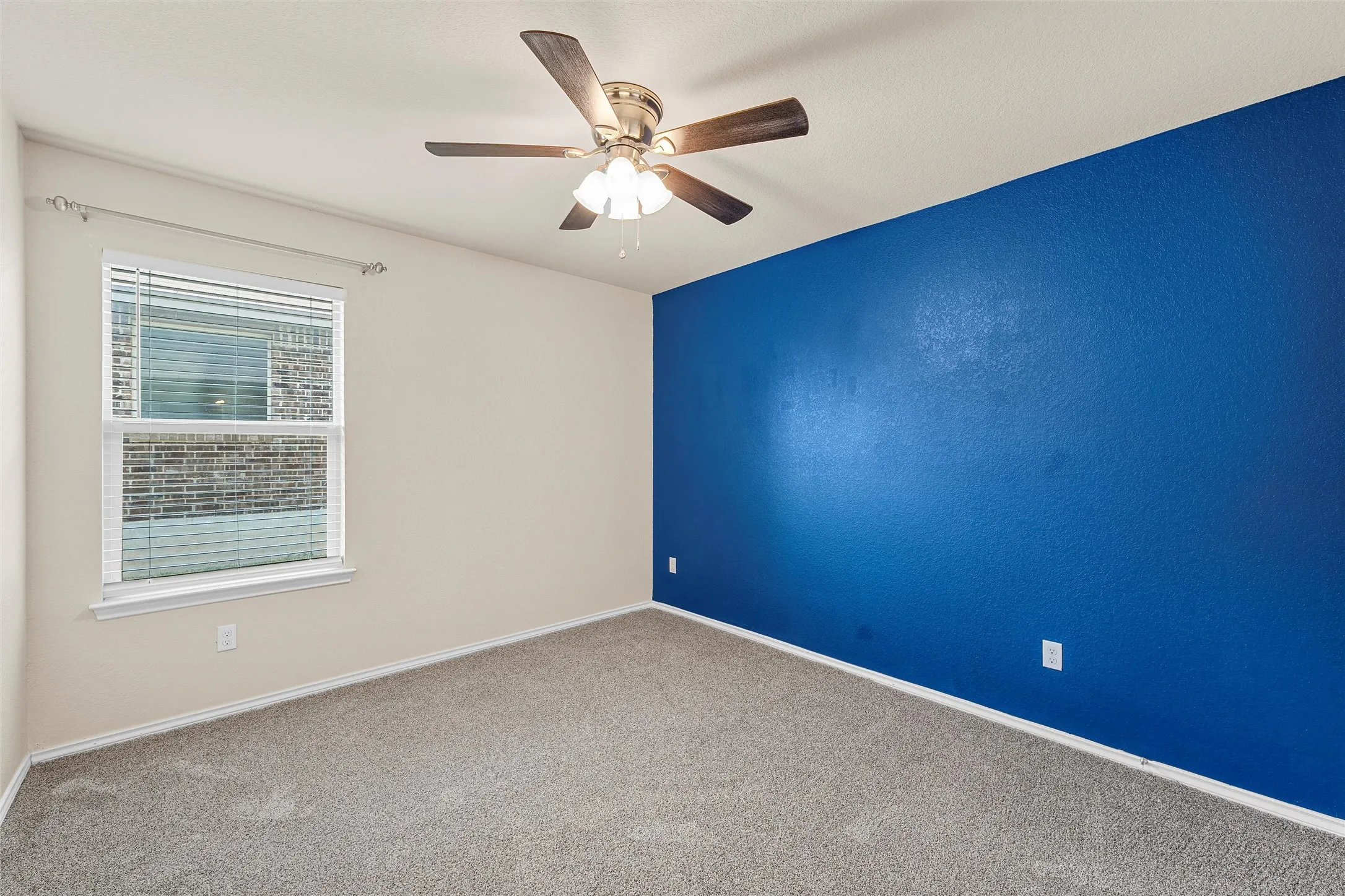 Spare room with carpet flooring and ceiling fan