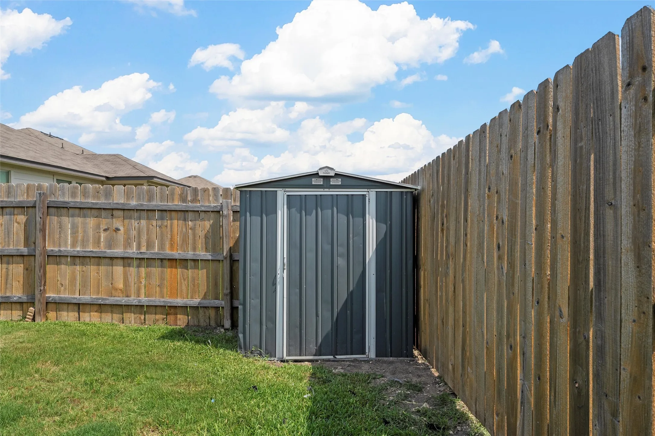 View of shed with a fenced backyard