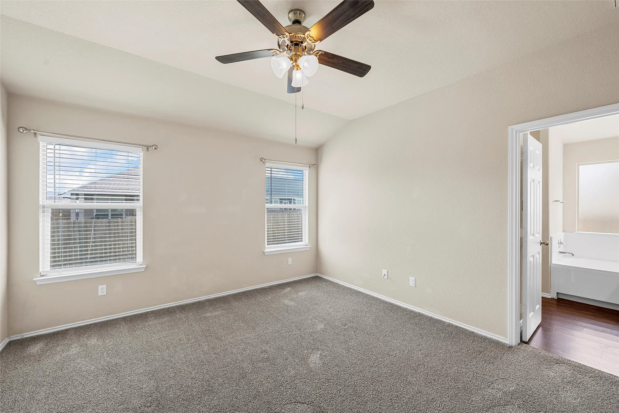 Unfurnished room with carpet, ceiling fan, and lofted ceiling
