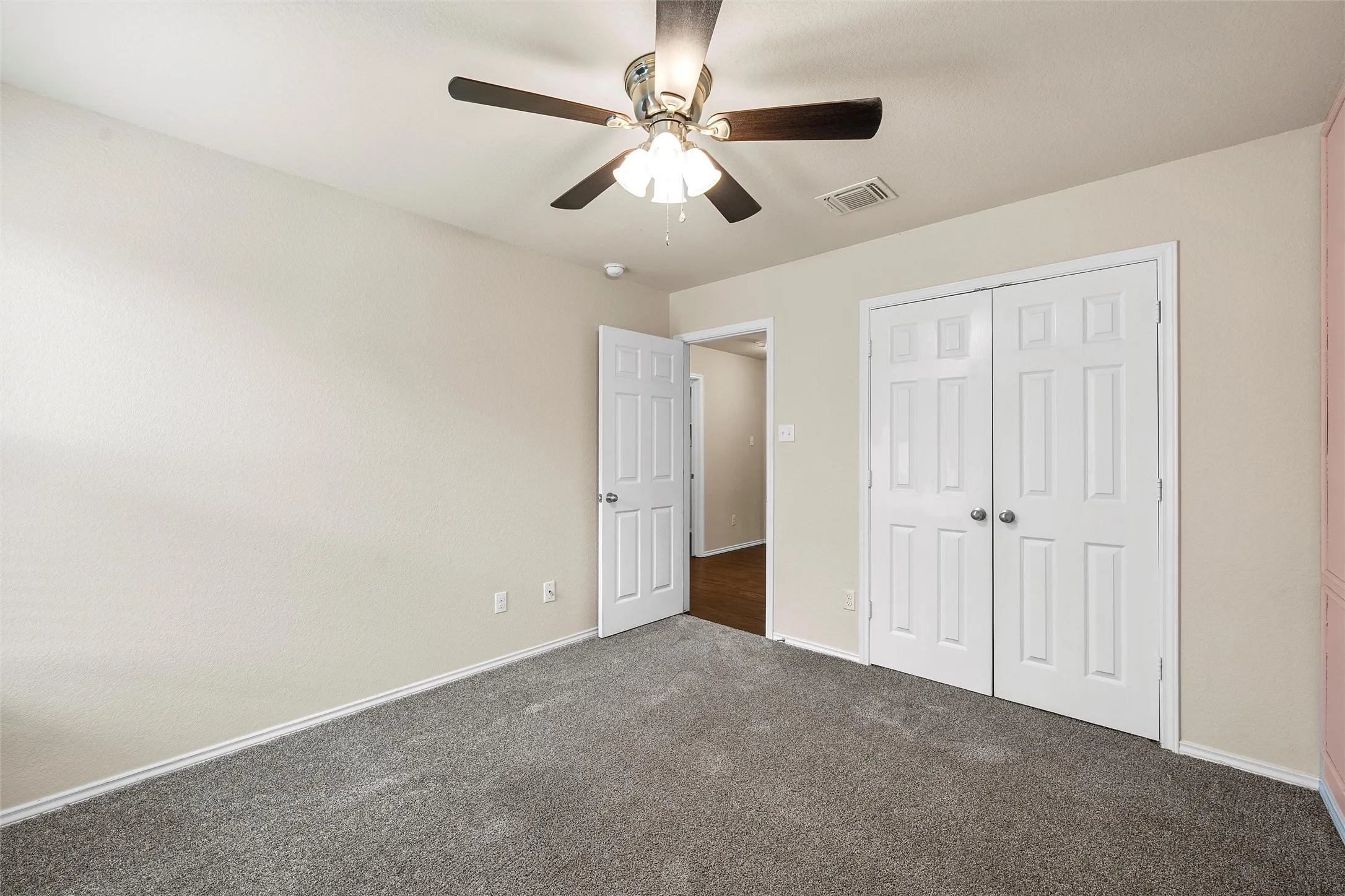 Unfurnished bedroom featuring carpet, a closet, and ceiling fan