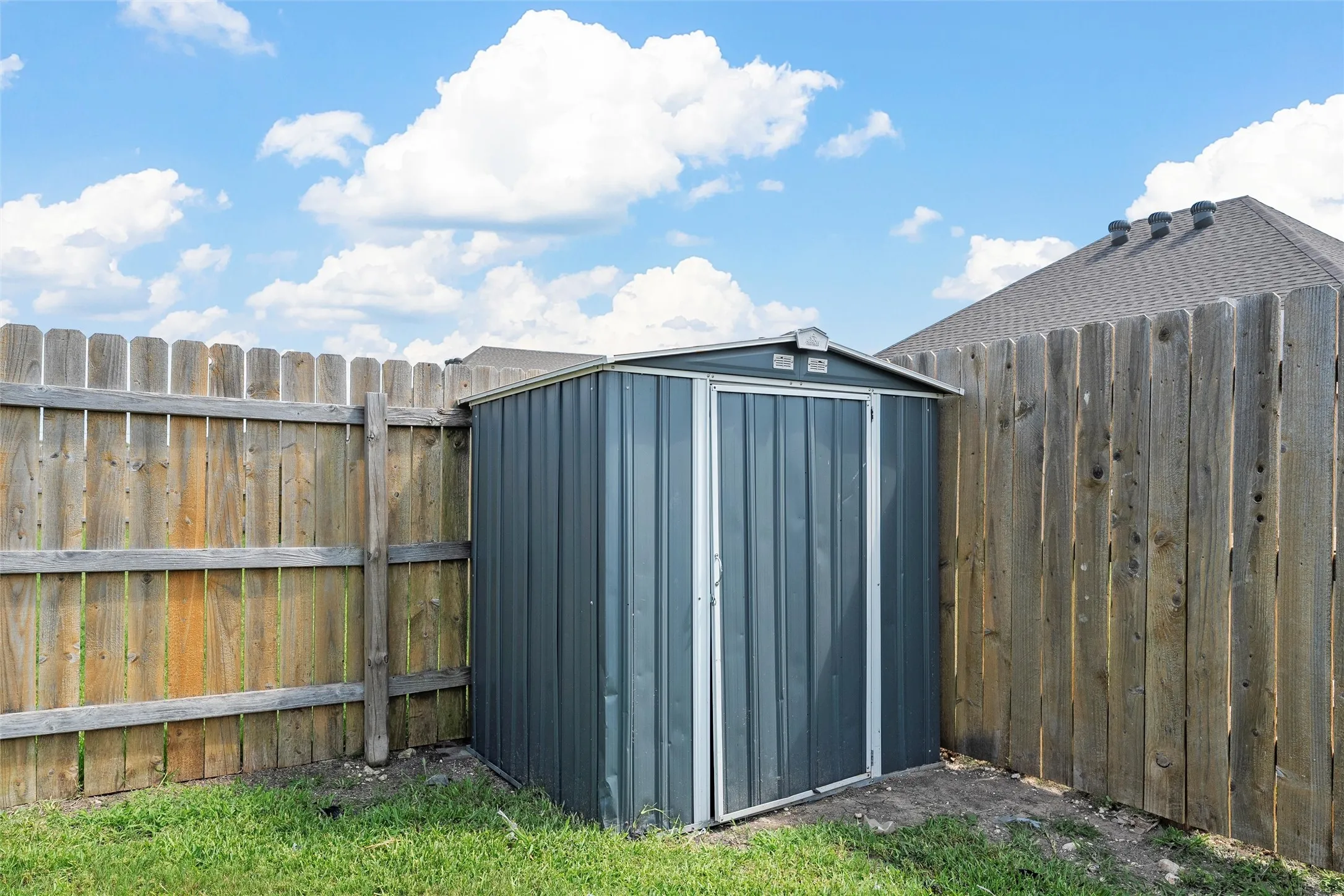 View of shed featuring a fenced backyard