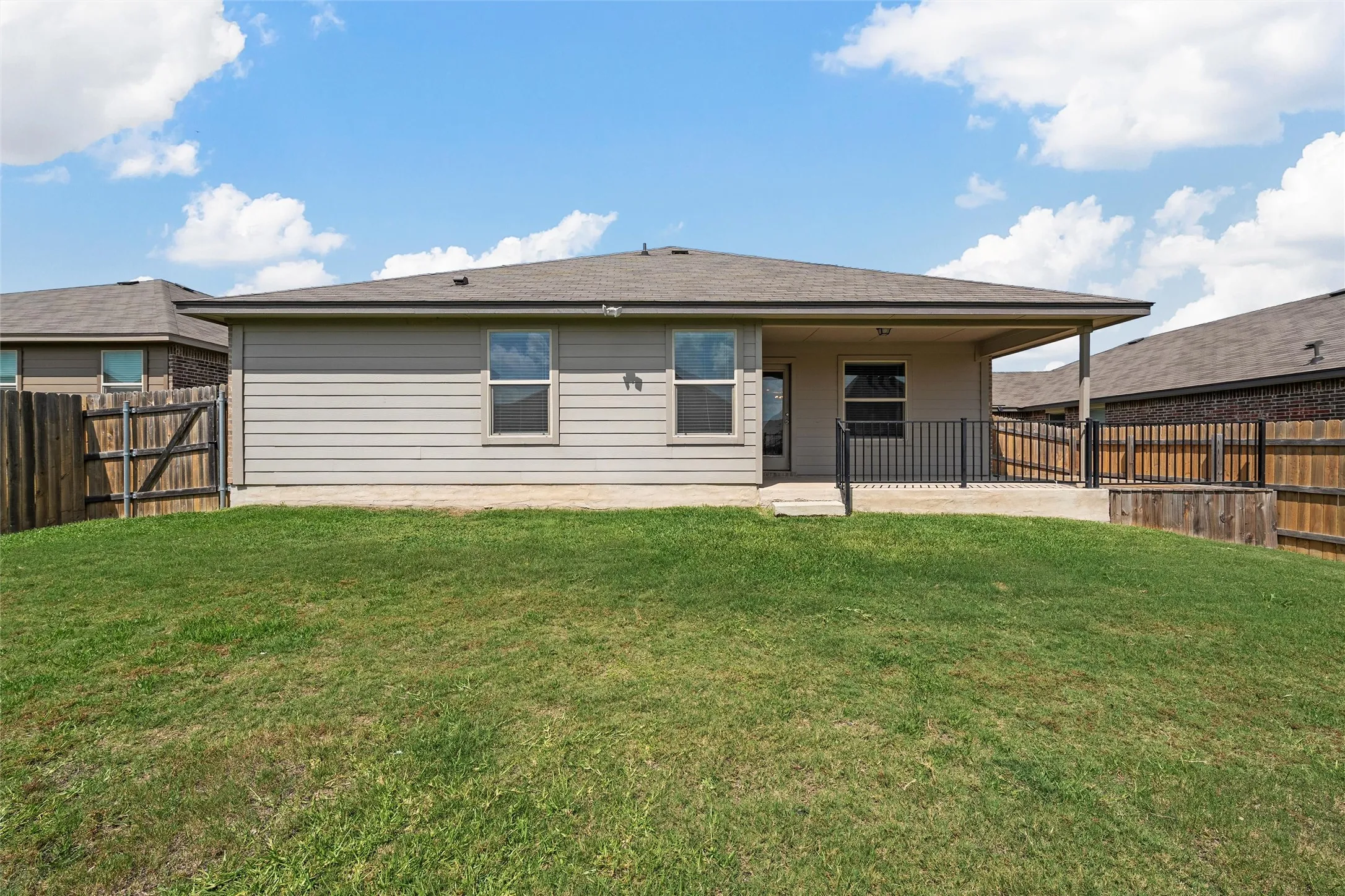 Back of property featuring a patio area and a fenced backyard