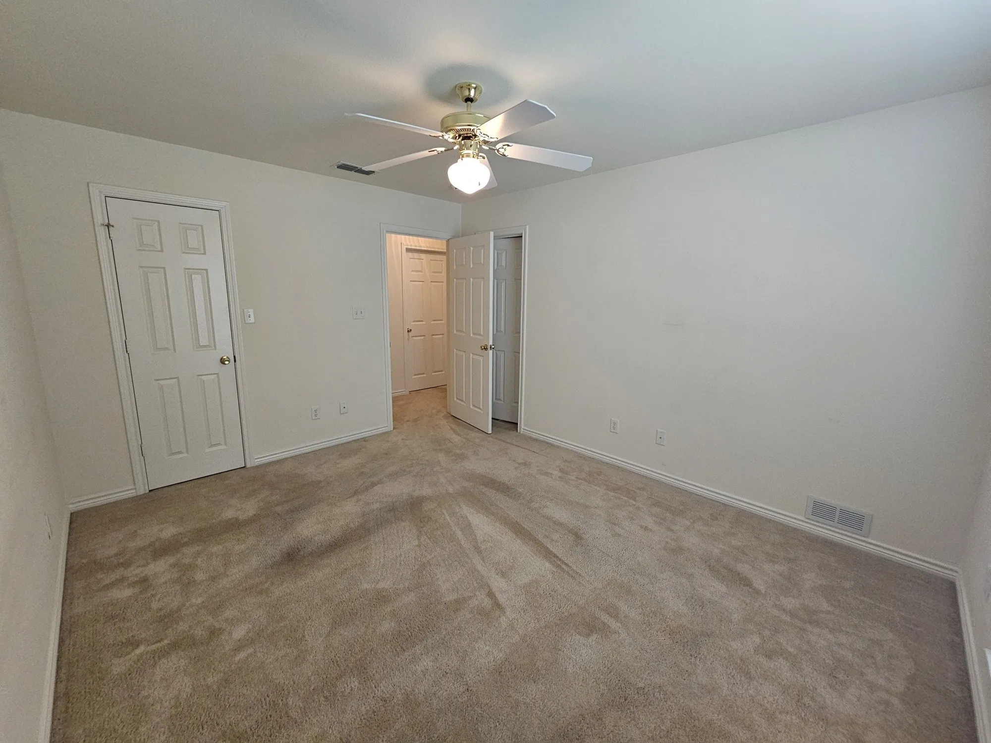 Neutral-toned carpet flooring and light-colored walls