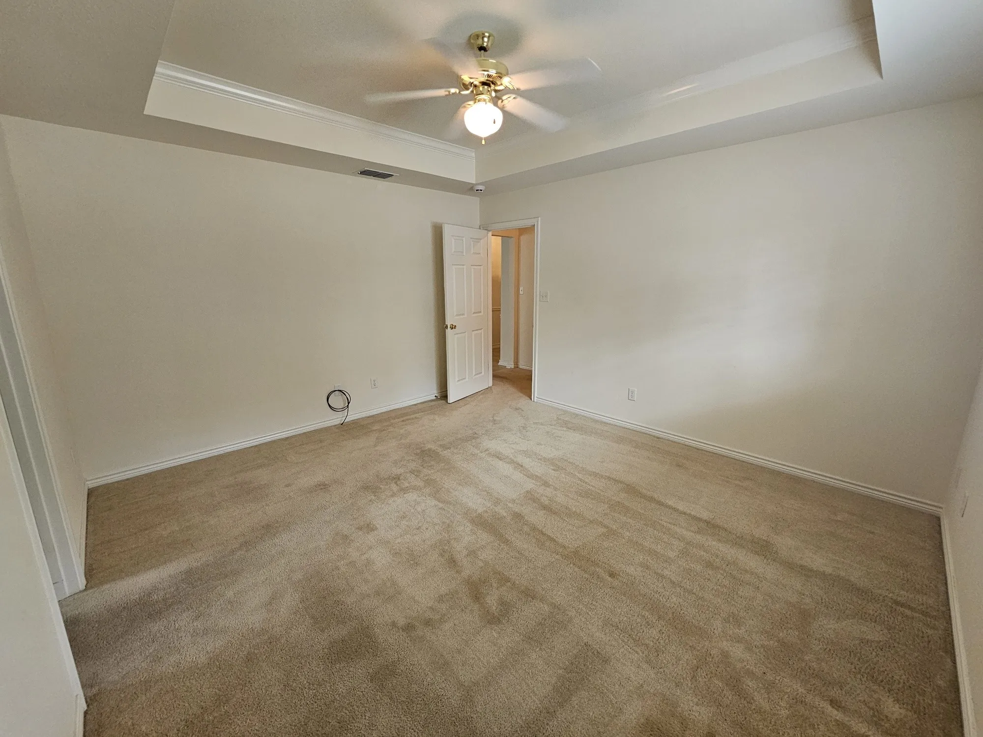 Walk-in closet with carpet flooring, multiple shelving units, and integrated hanging rods