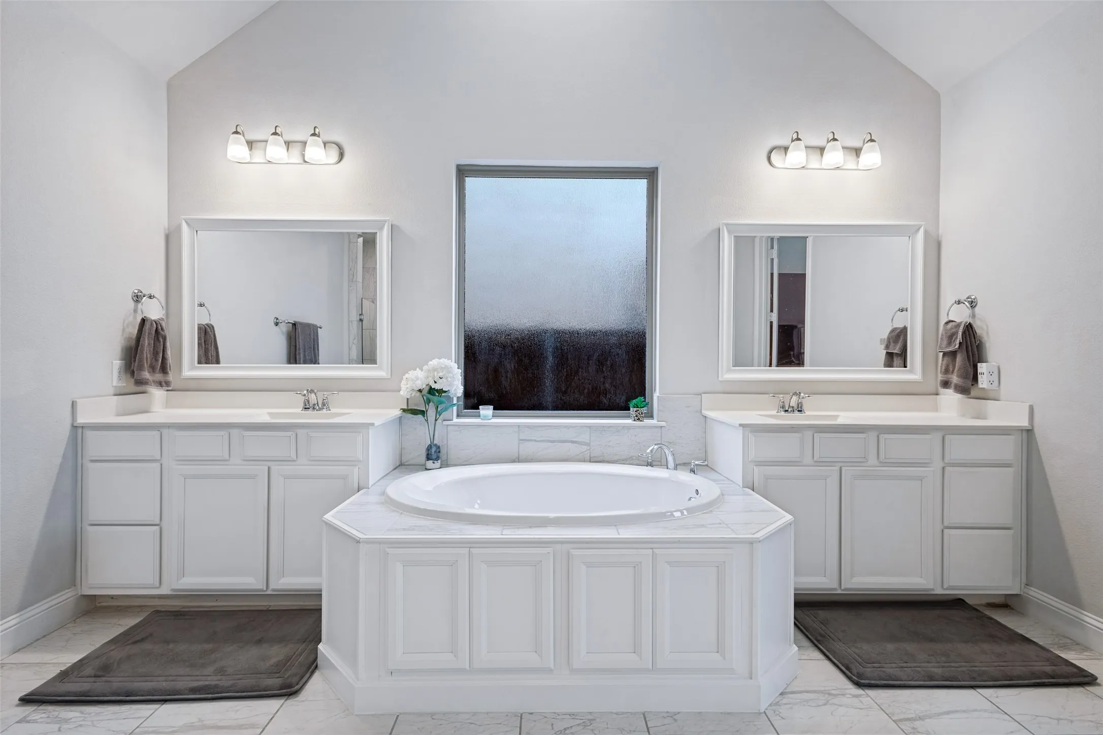 Double sinks with large built in tub. Frosted window glass to let in lots of natural lighting!