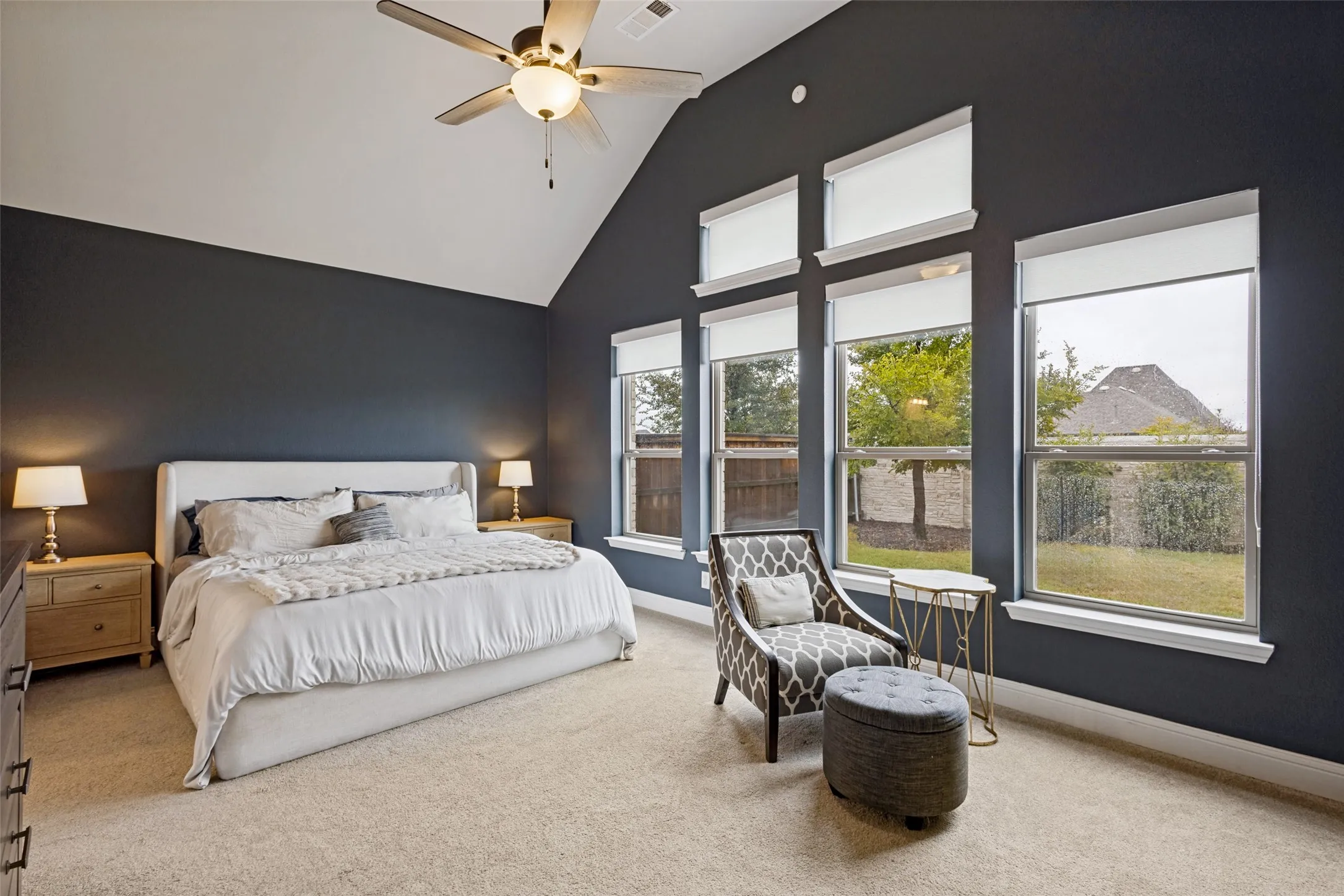 Large primary bedroom with large windows