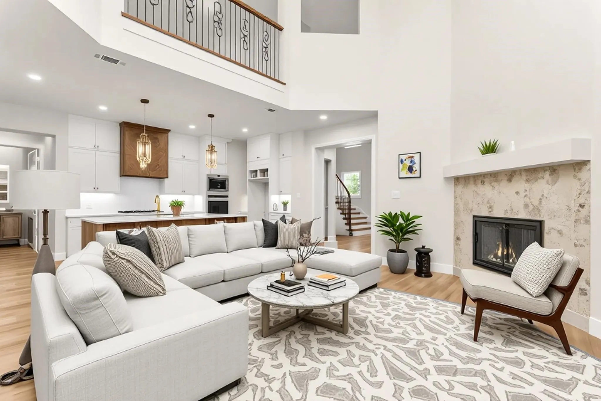 Soaring ceilings with an upper-level balcony featuring decorative metal railings
