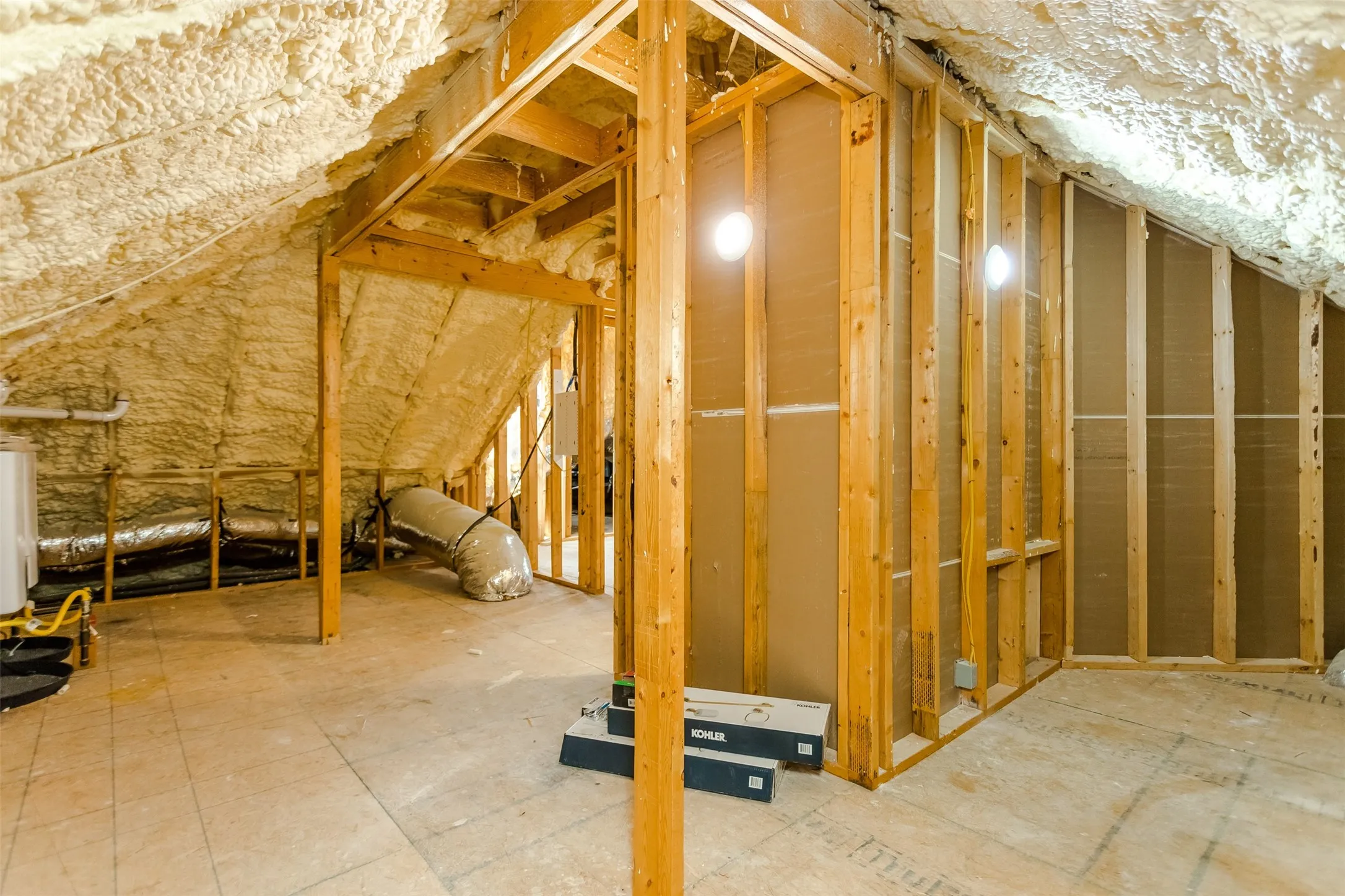 Exposed wood framing, spray foam insulation, and visible ductwork