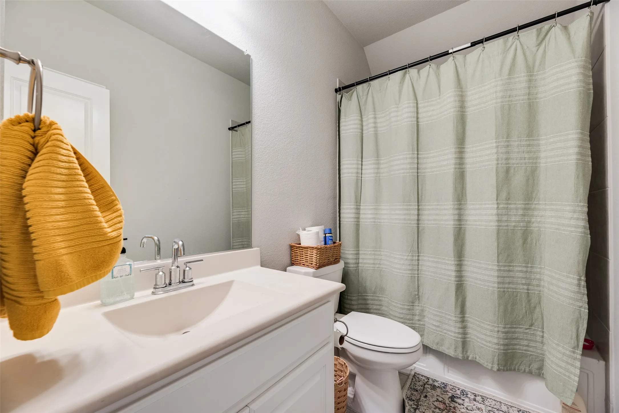 Integrated single-basin vanity with polished chrome faucet and frameless mirror