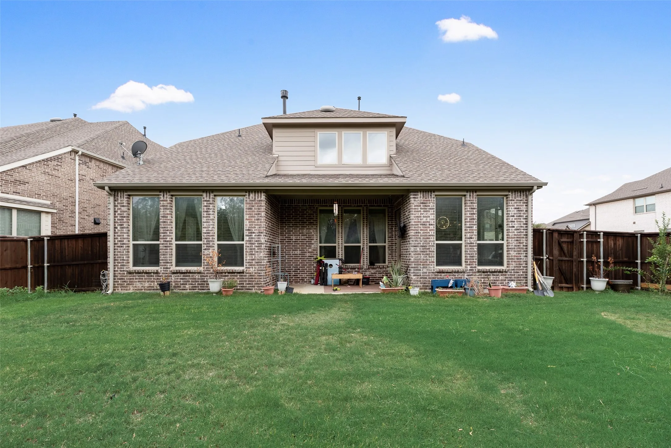 Expansive grassy yard with a full privacy fence