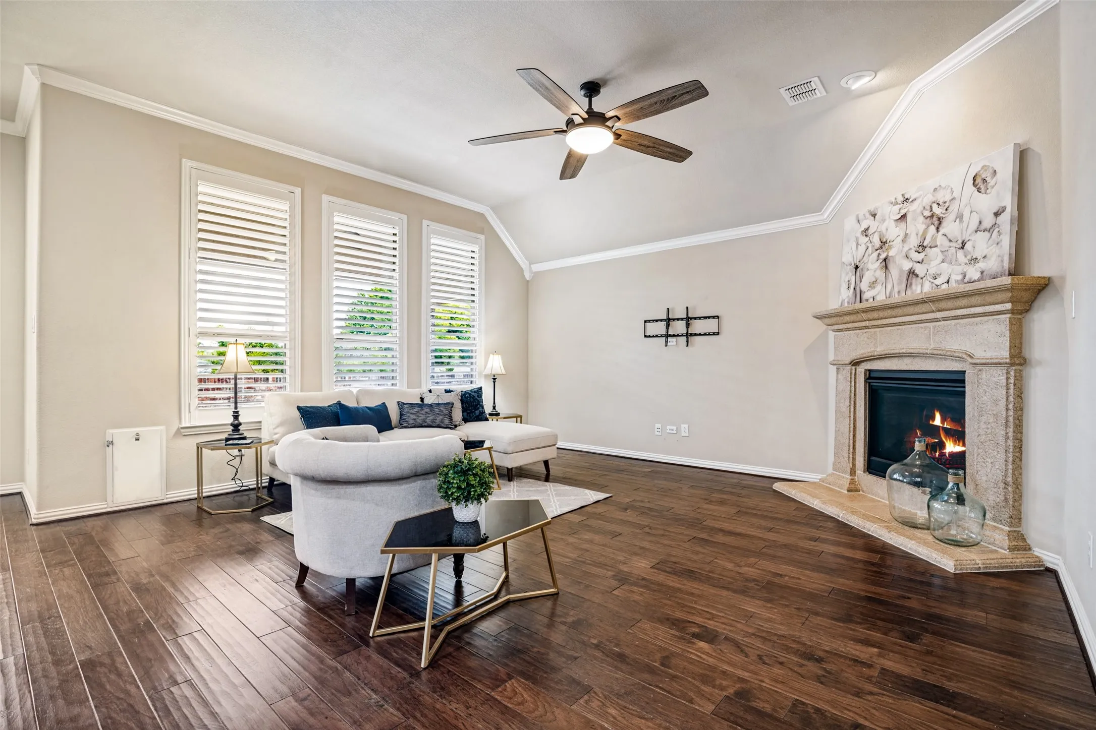 living room with gas fireplace overlooks back yard