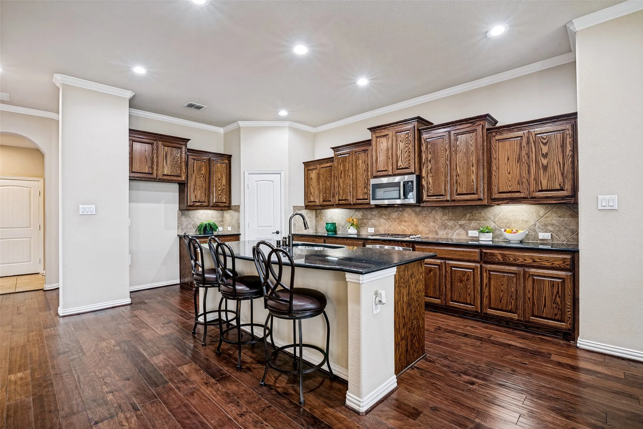 Stunning oversized Kitchen has Great Island, stainless appliances, including gas cooktop.