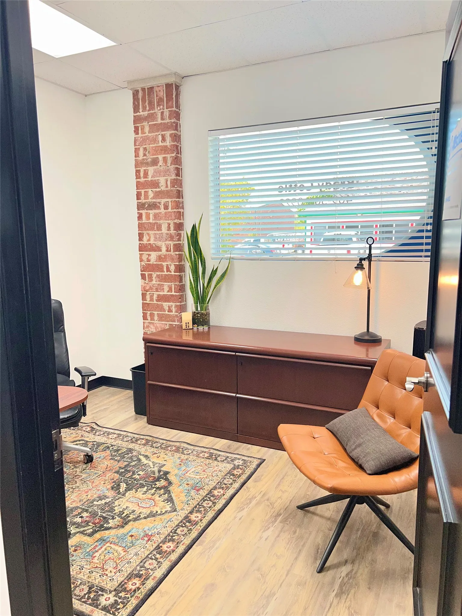 Wood-finish flooring with a brick accent wall