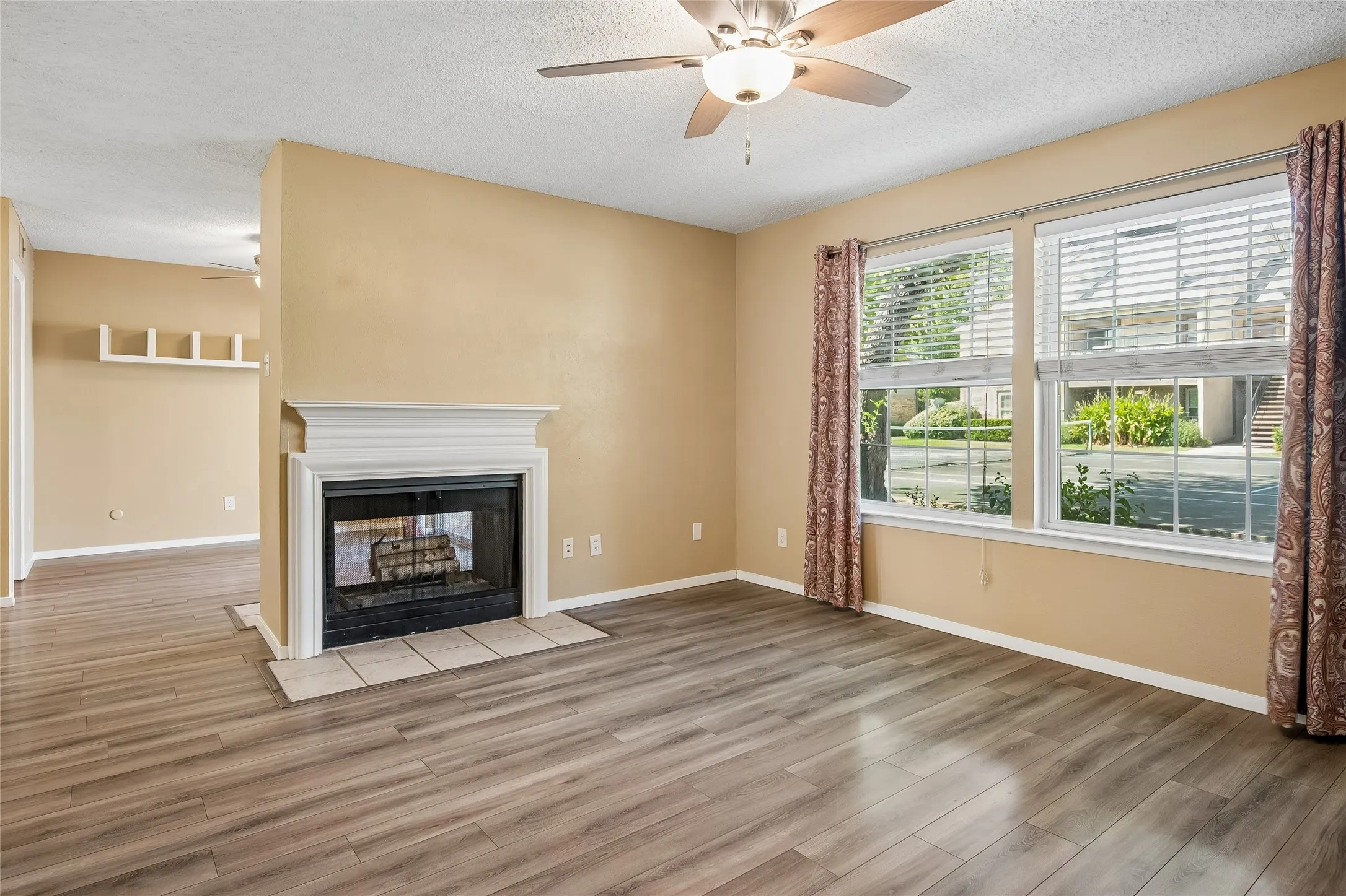 Living room with see through fireplace and ceiling fan