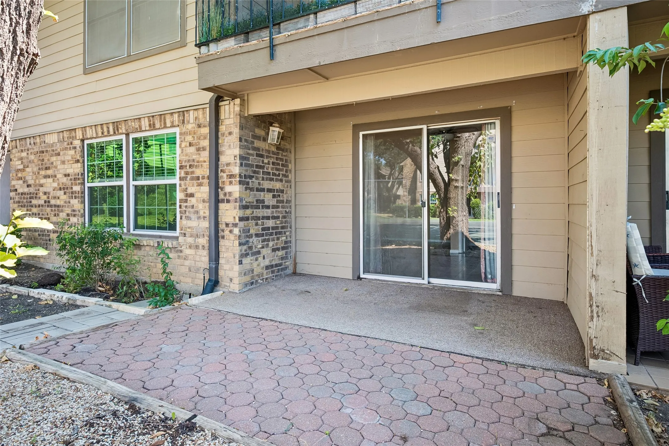 Patio with large shade tree (not pictured)