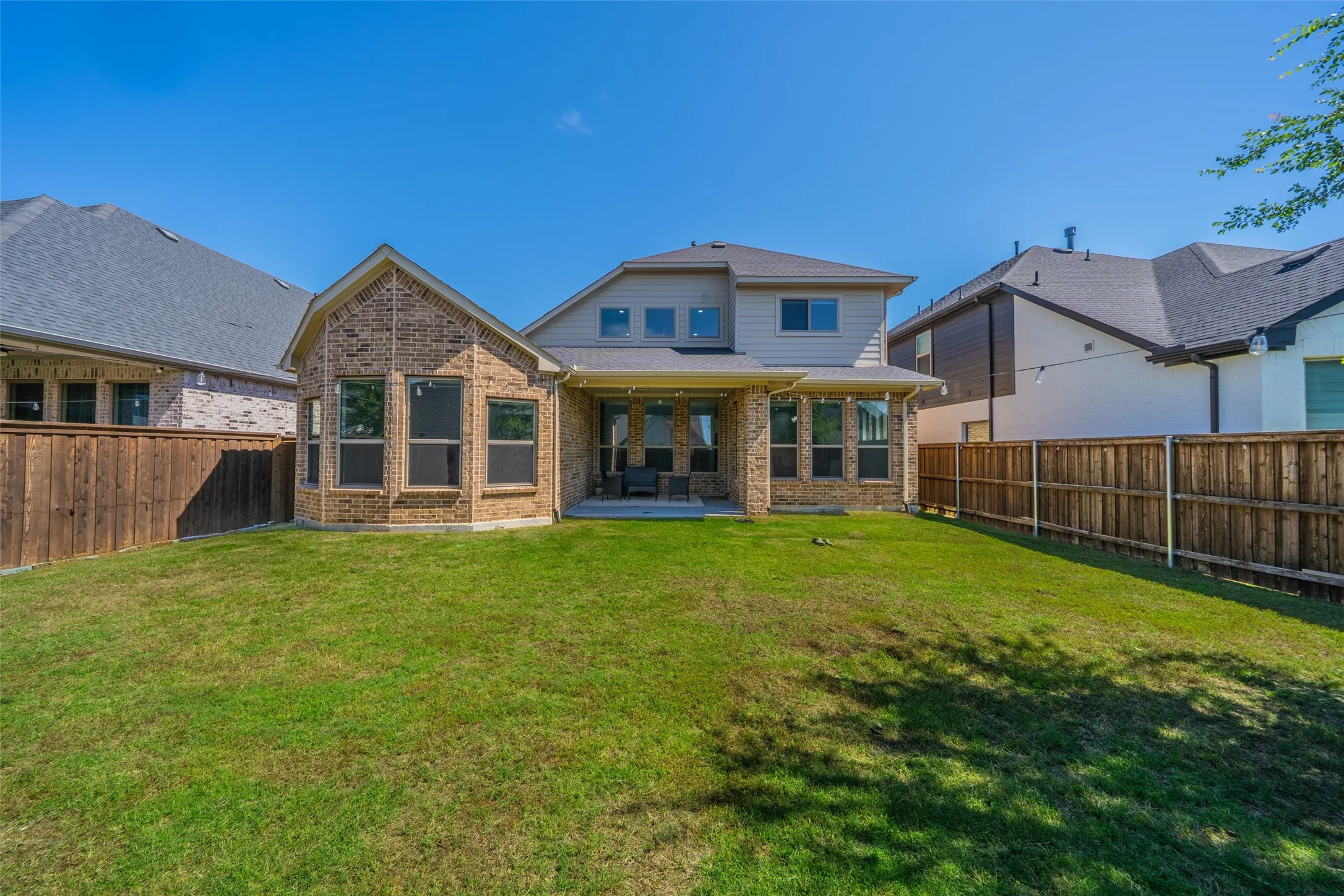 Expansive lawn with wood privacy fencing