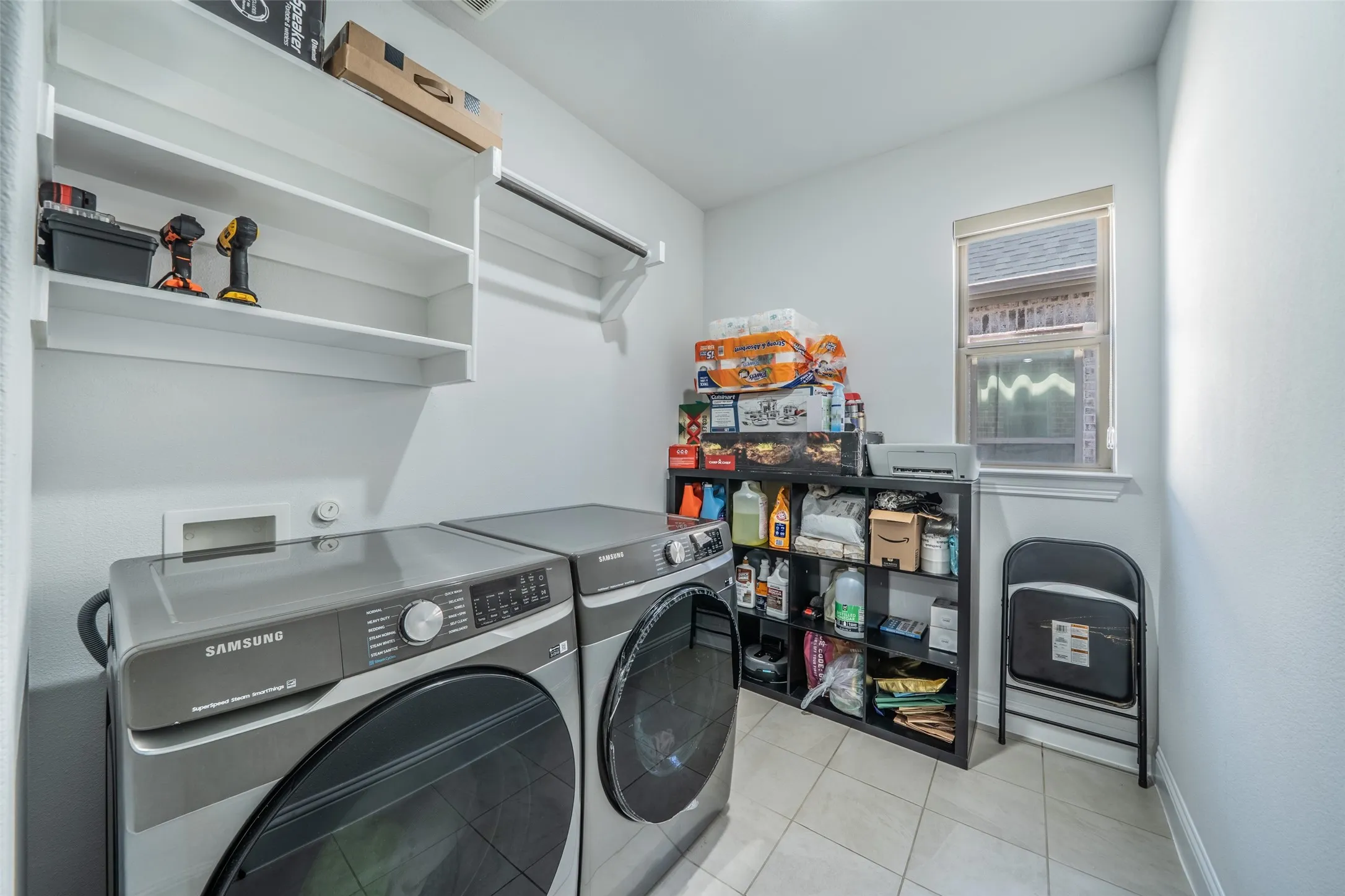 Tiled flooring, built-in shelving, and a mounted clothing rod