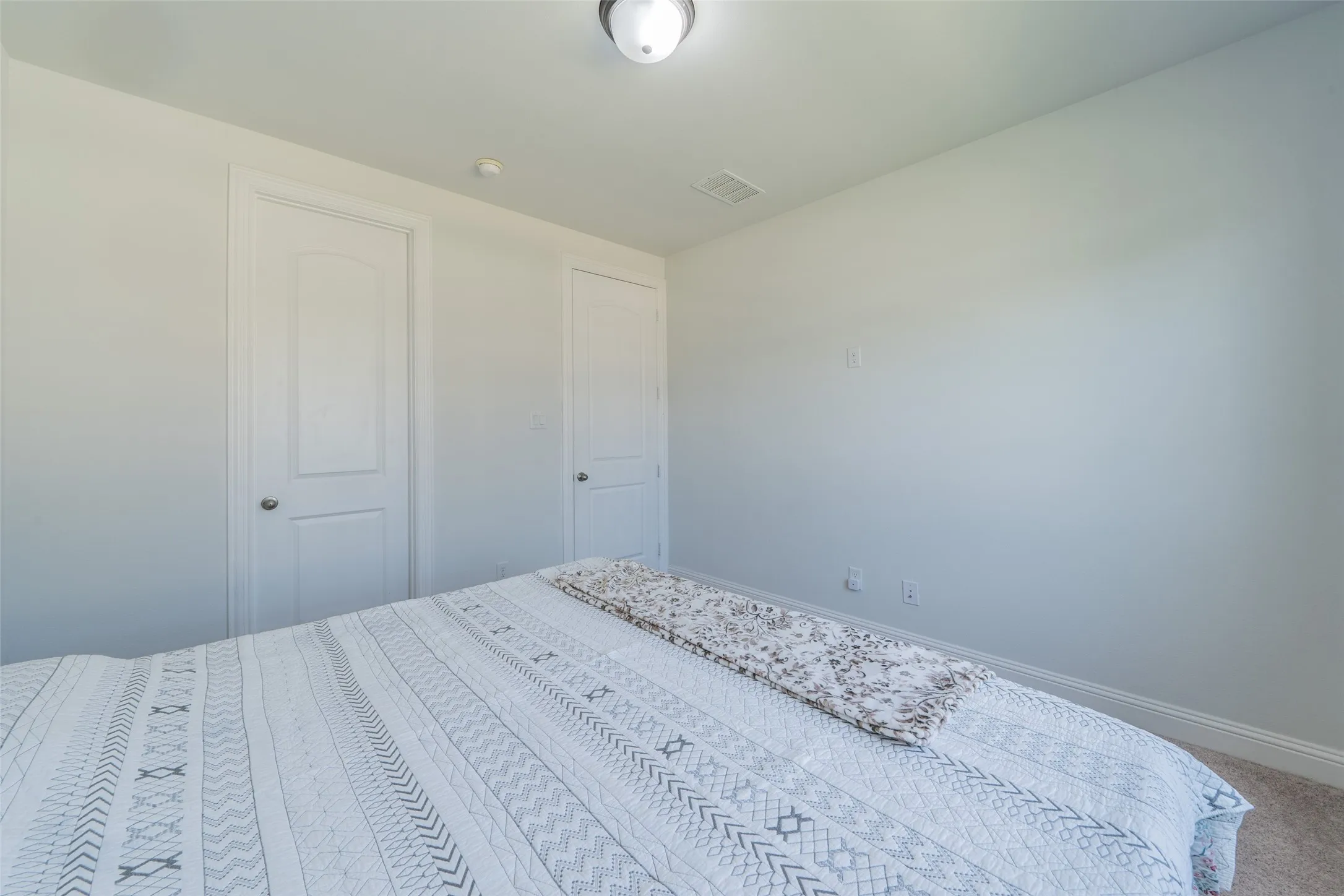 Recessed ceiling light fixture and two interior doors with curved paneling